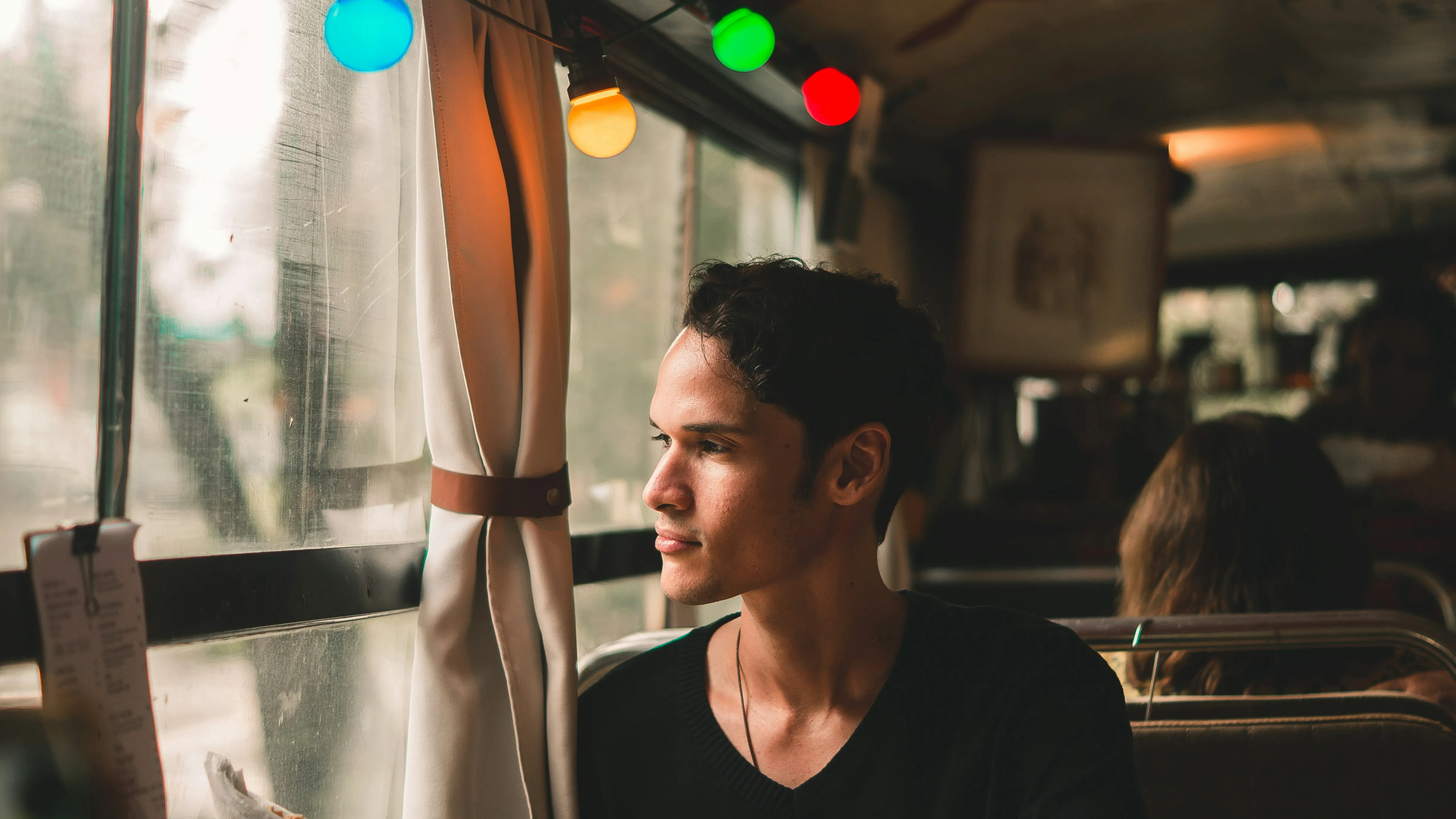 Man Sitting Indoors Reflecting in Soft Lighting Wallpaper