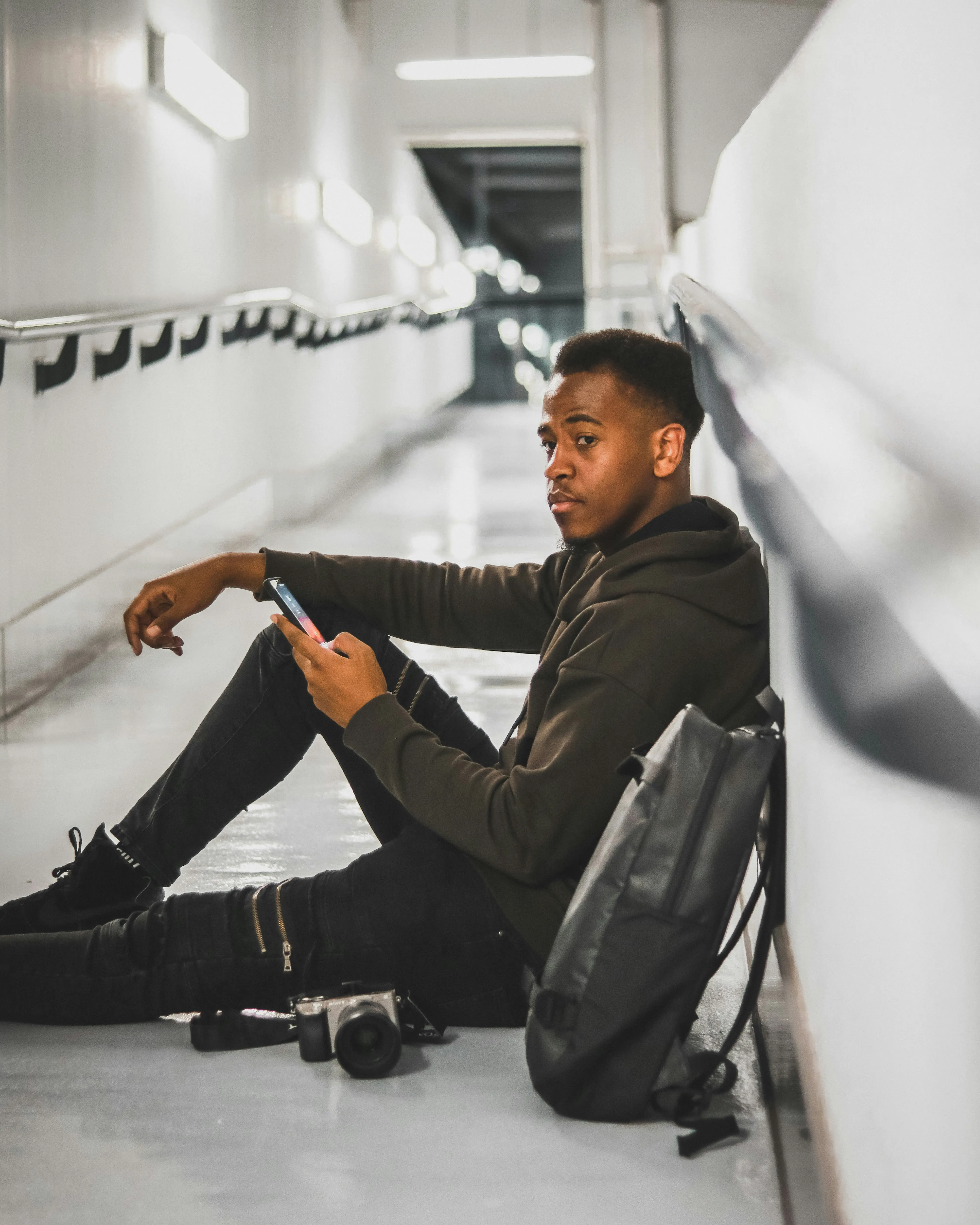 Man Sitting Thoughtfully in Modern Bright Hallway Wallpaper