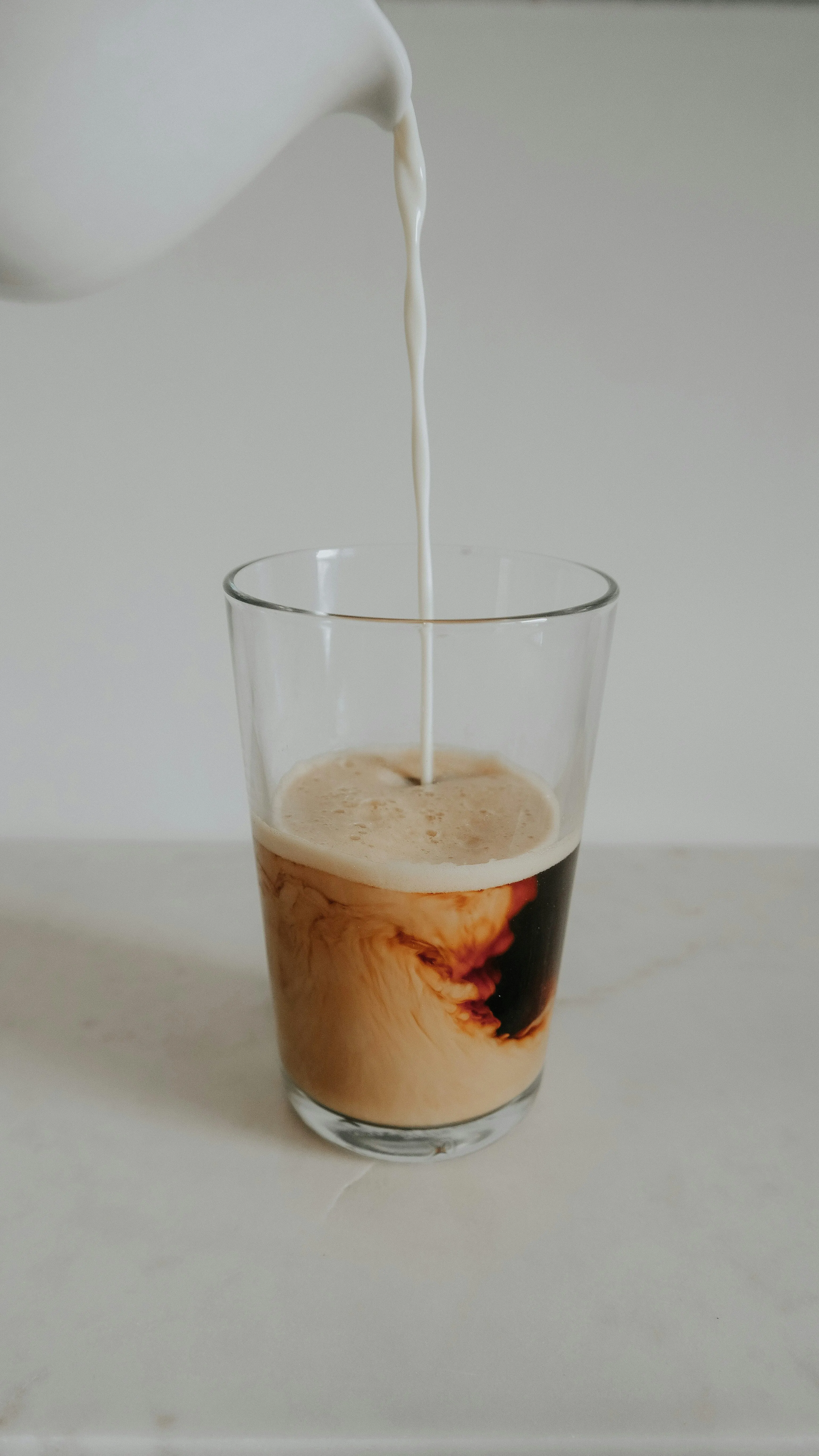 Milk Pouring into Glass with Elegant Simplicity Wallpaper