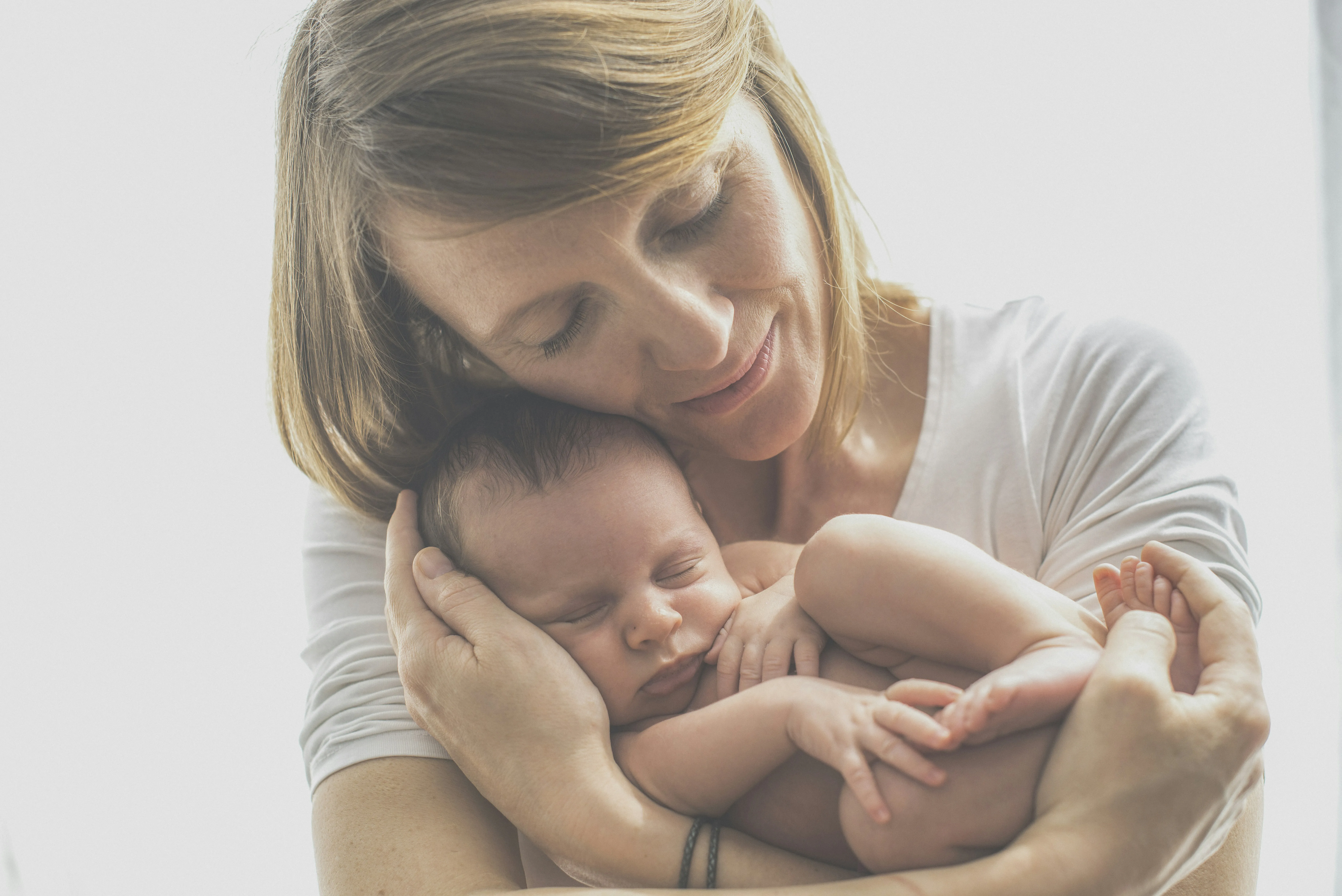 Mother Holding Baby Showing Pure Family Love Wallpaper