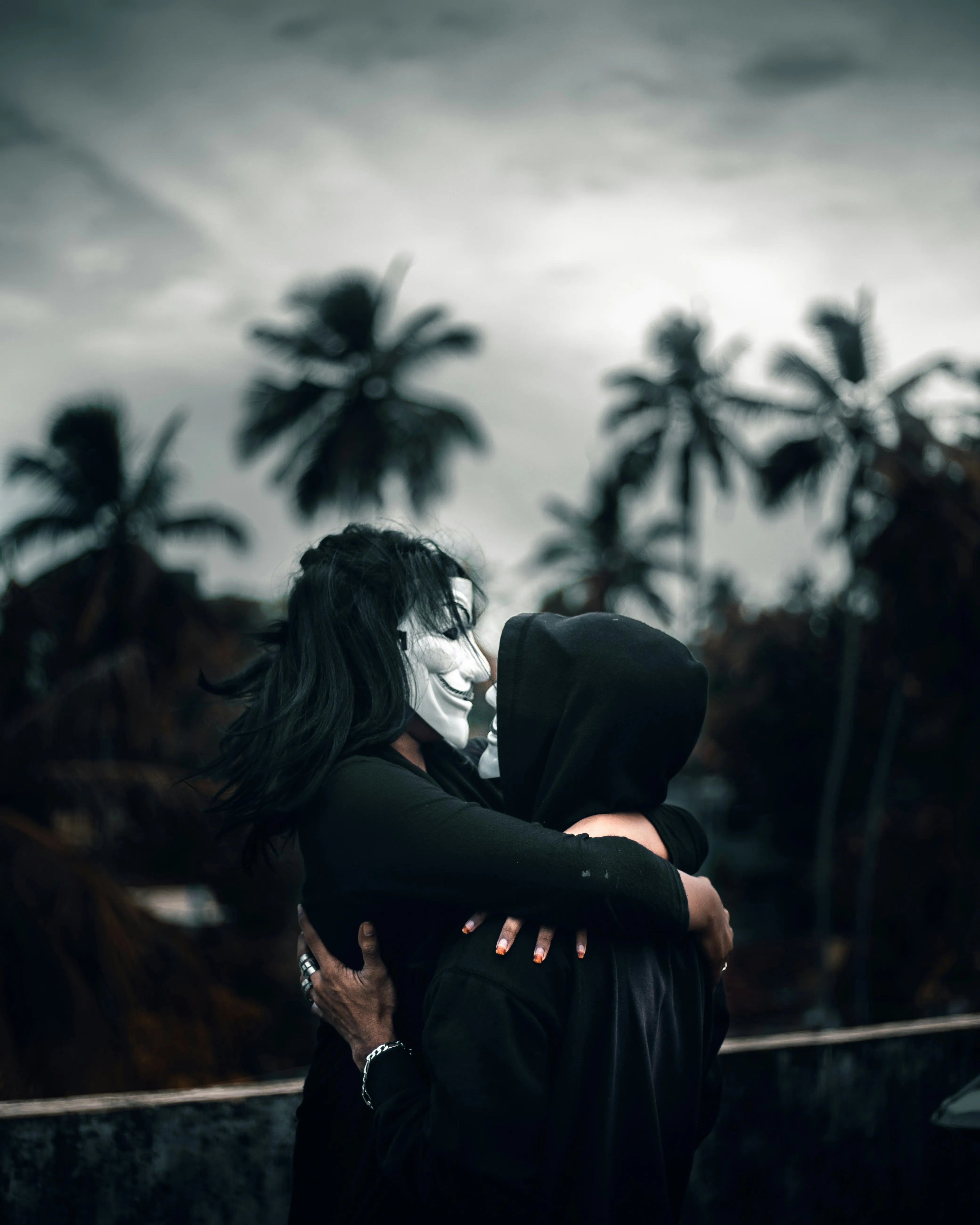Mysterious Couple in Masks Sharing an Intense Embrace