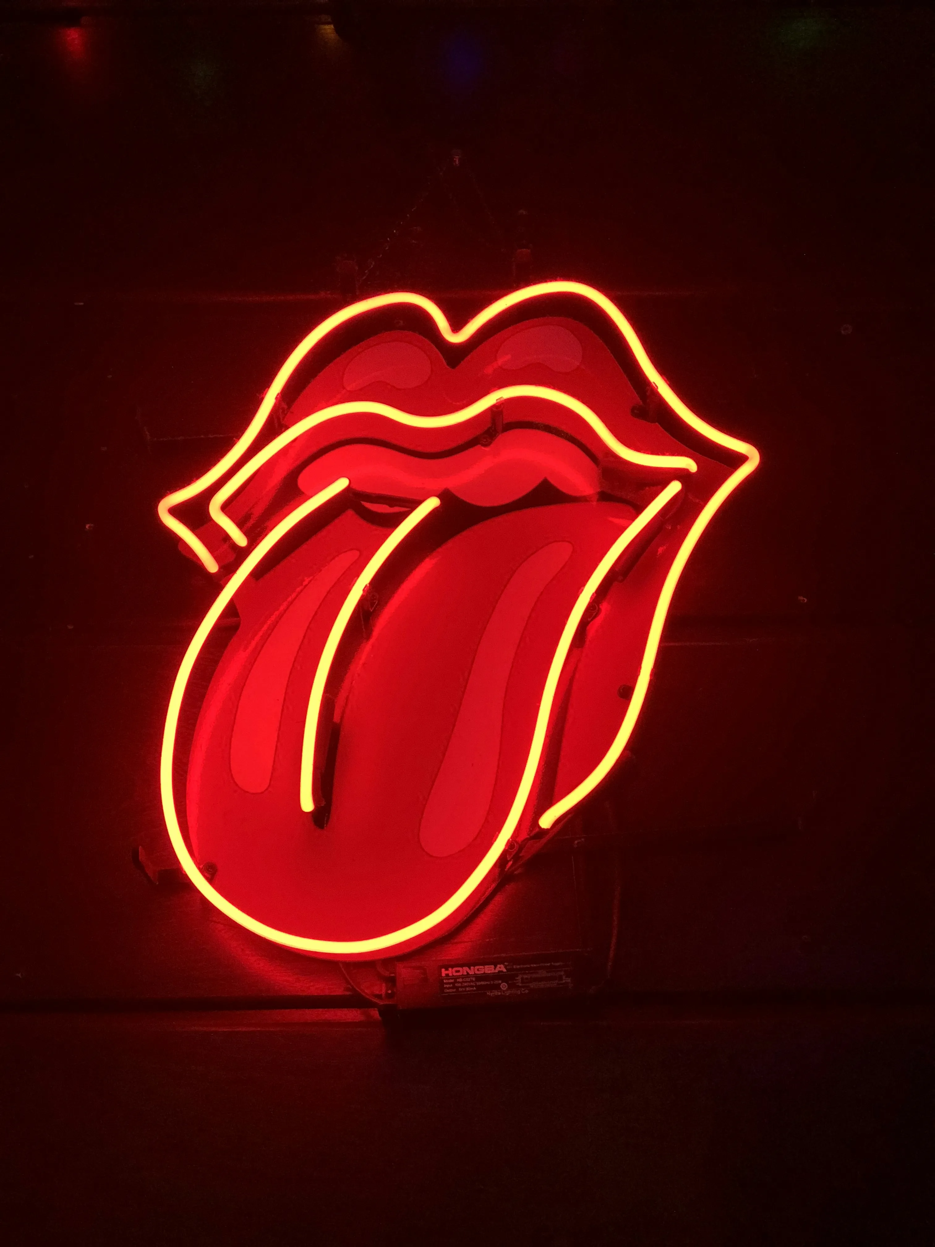 Neon Sign of Red Lips on Dark Urban Wall Wallpaper