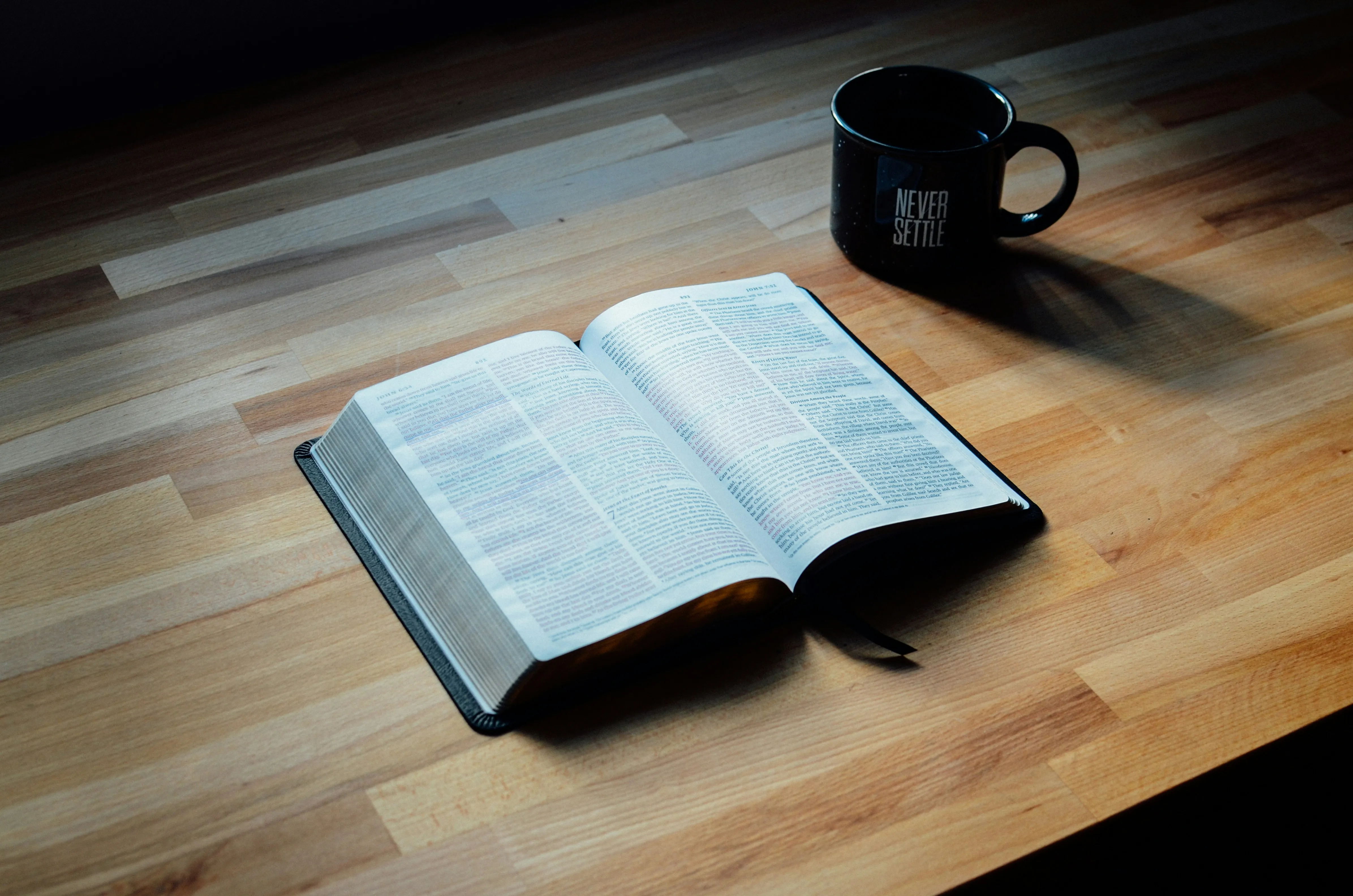 Open Book and Coffee Mug on Wooden Table Wallpaper