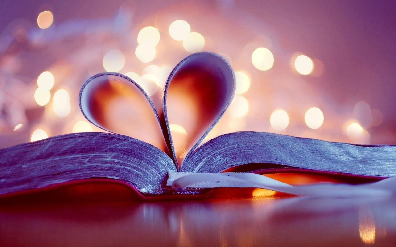 Open Book Forming Heart with Warm Bokeh Lights Wallpaper