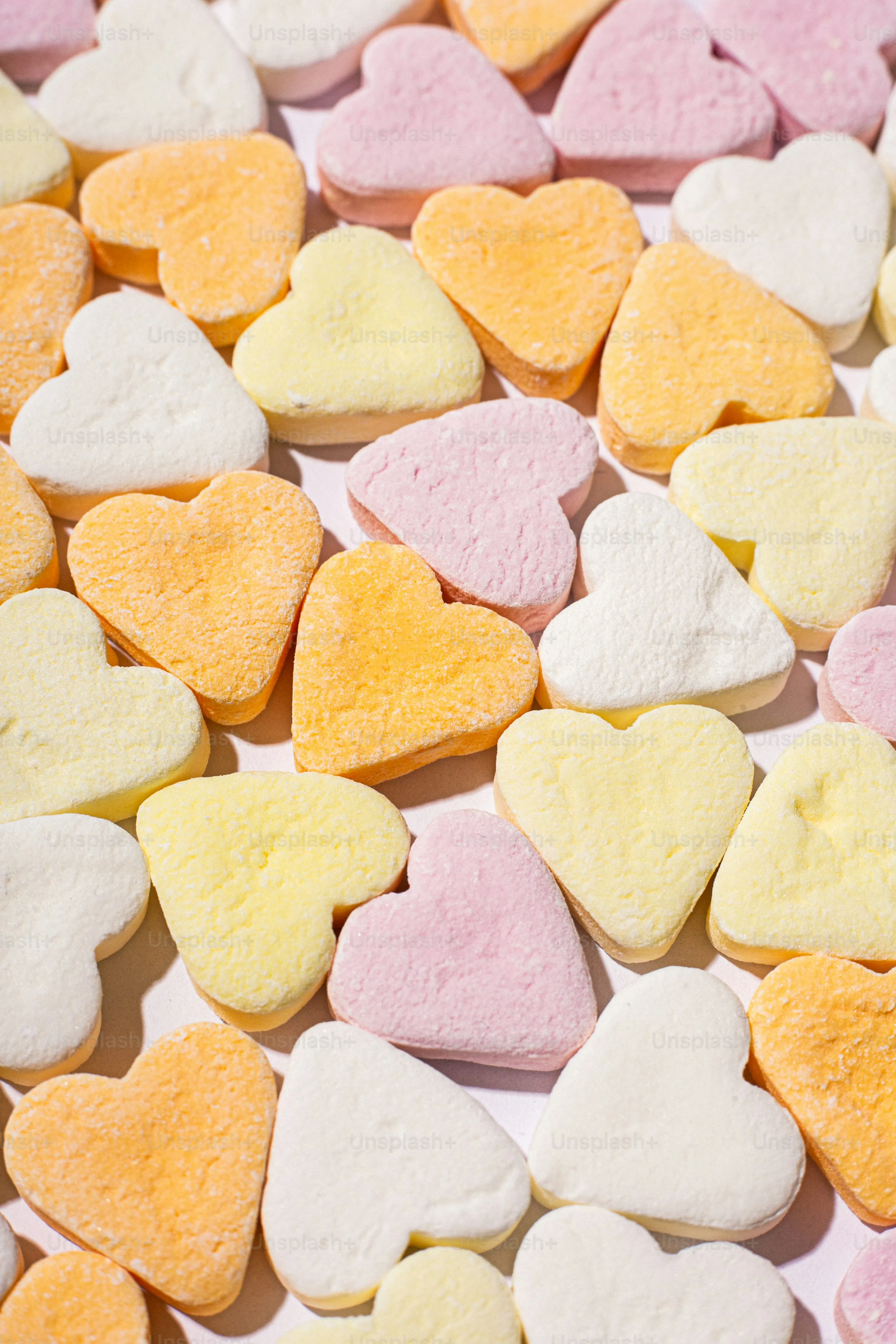 Pastel Candy Hearts Spread in Soft Background Wallpaper