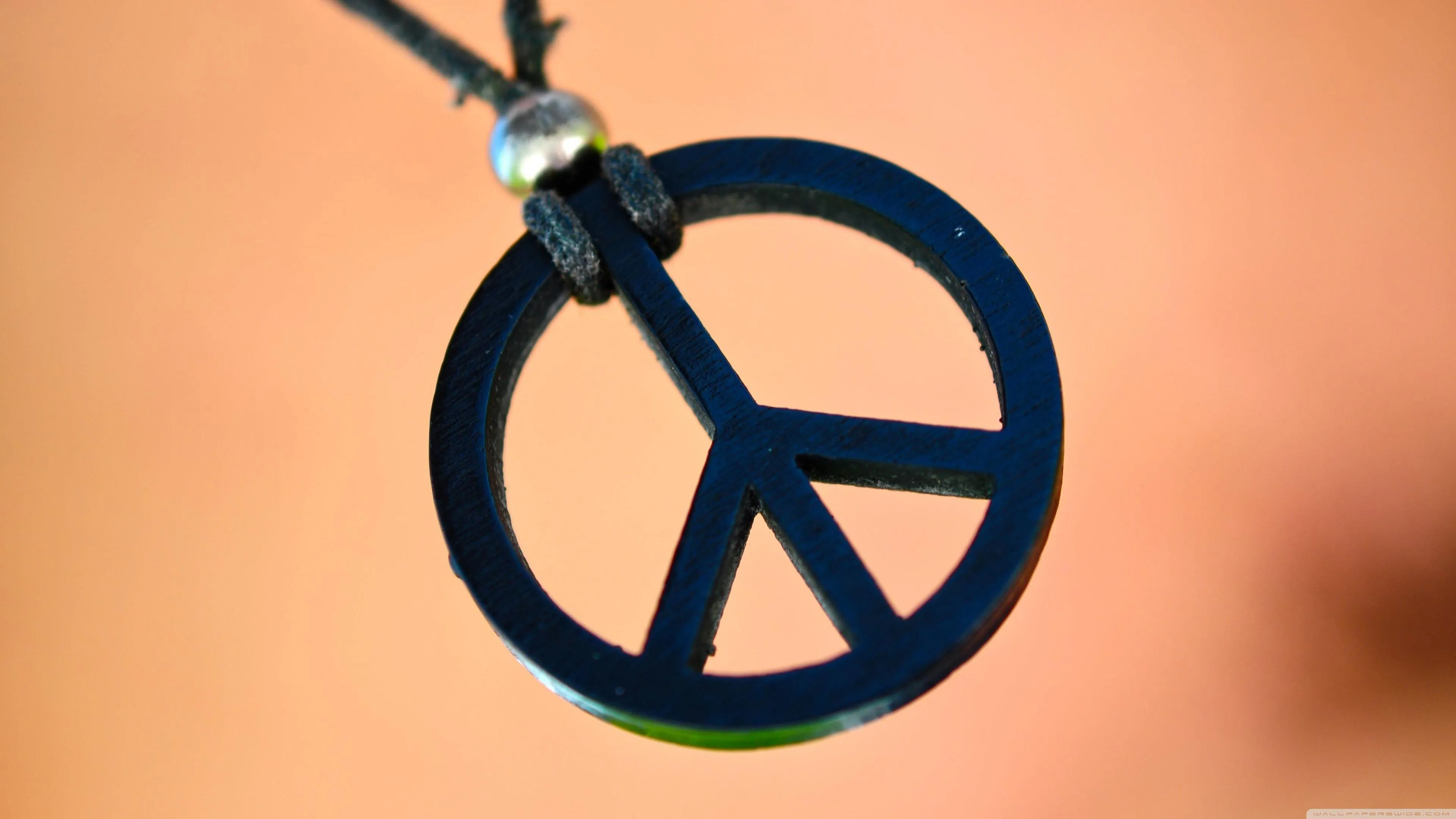 Peace Symbol Pendant Reflecting Hope and Harmony Wallpaper