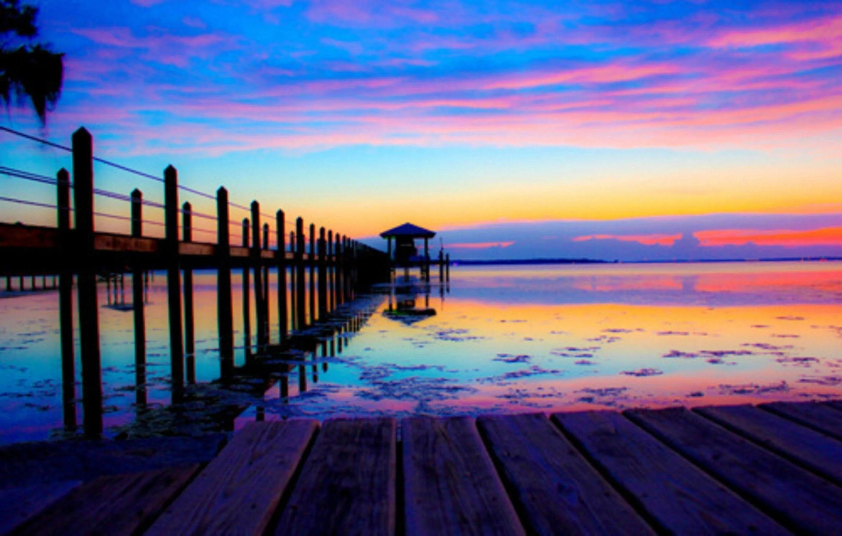 Peaceful Pier Sunset Reflecting Calmness and Love Wallpaper