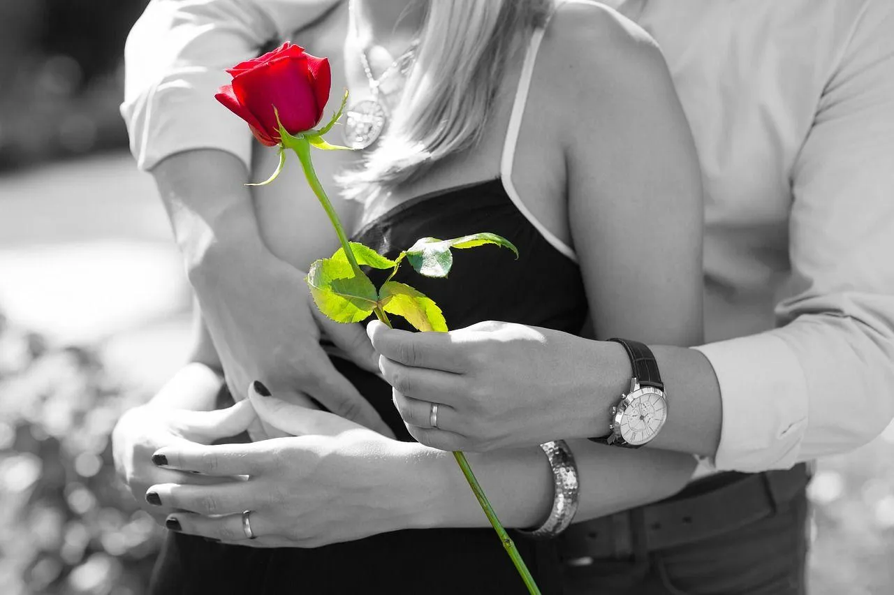 Person Holding Rose Expressing Romantic Gesture Wallpaper