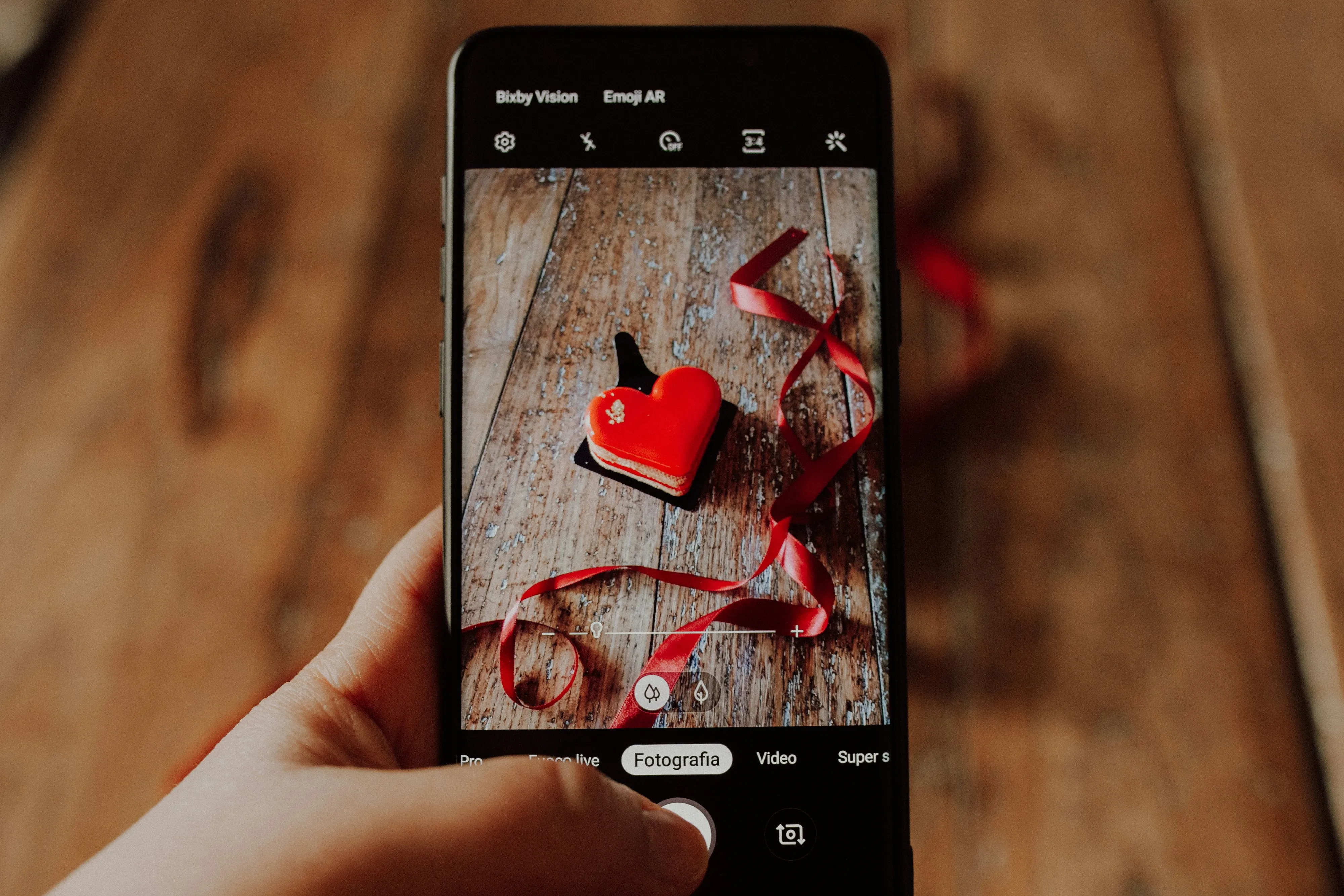 Person Taking Photo of Heart Shape with Mobile Wallpaper