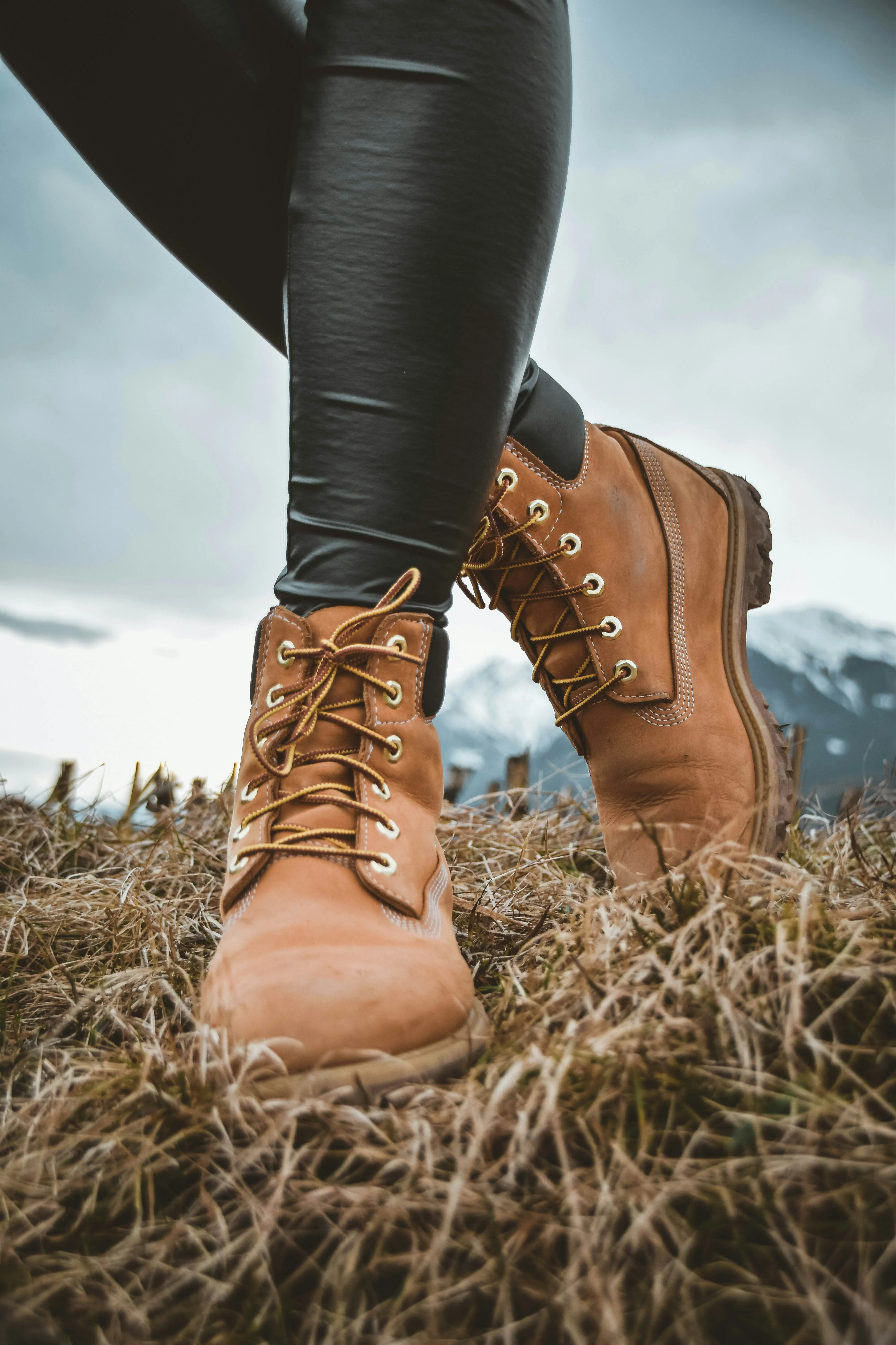 Person Wearing Brown Boots Standing in Field Wallpaper