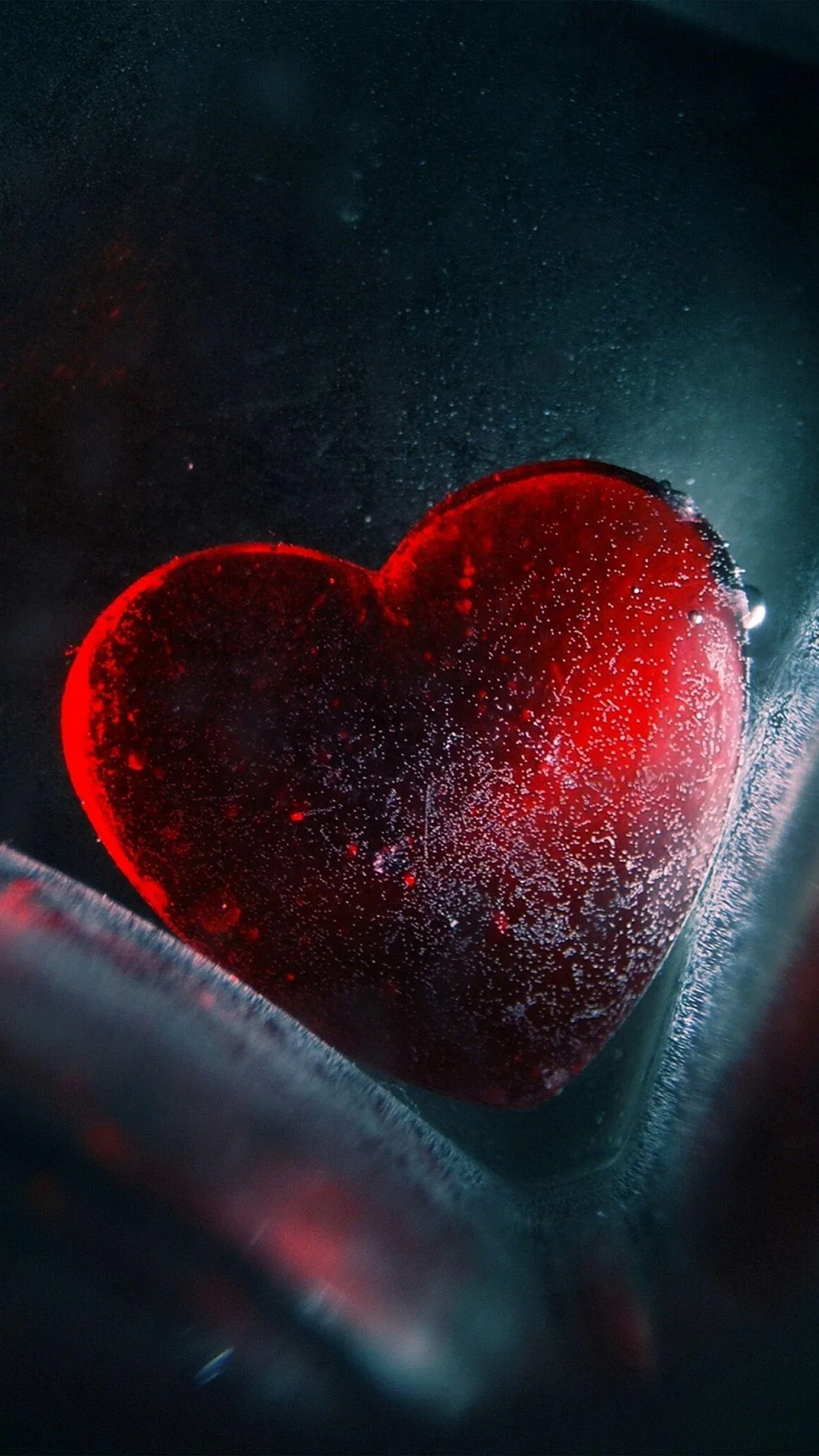 Red Heart Floating in Dark Space Reflecting Hope Wallpaper