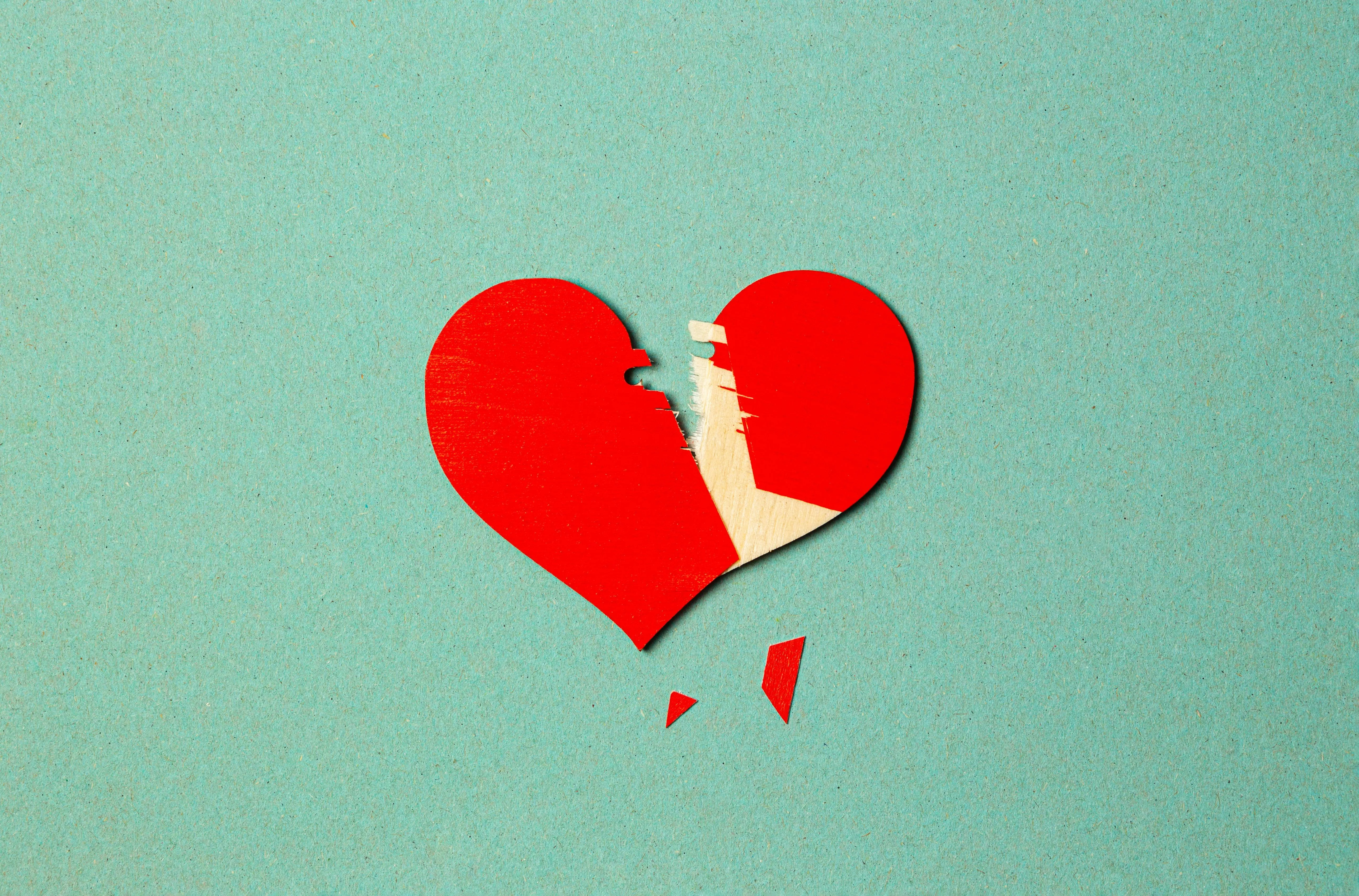Red Heart Torn Apart Showing Love Separation Wallpaper