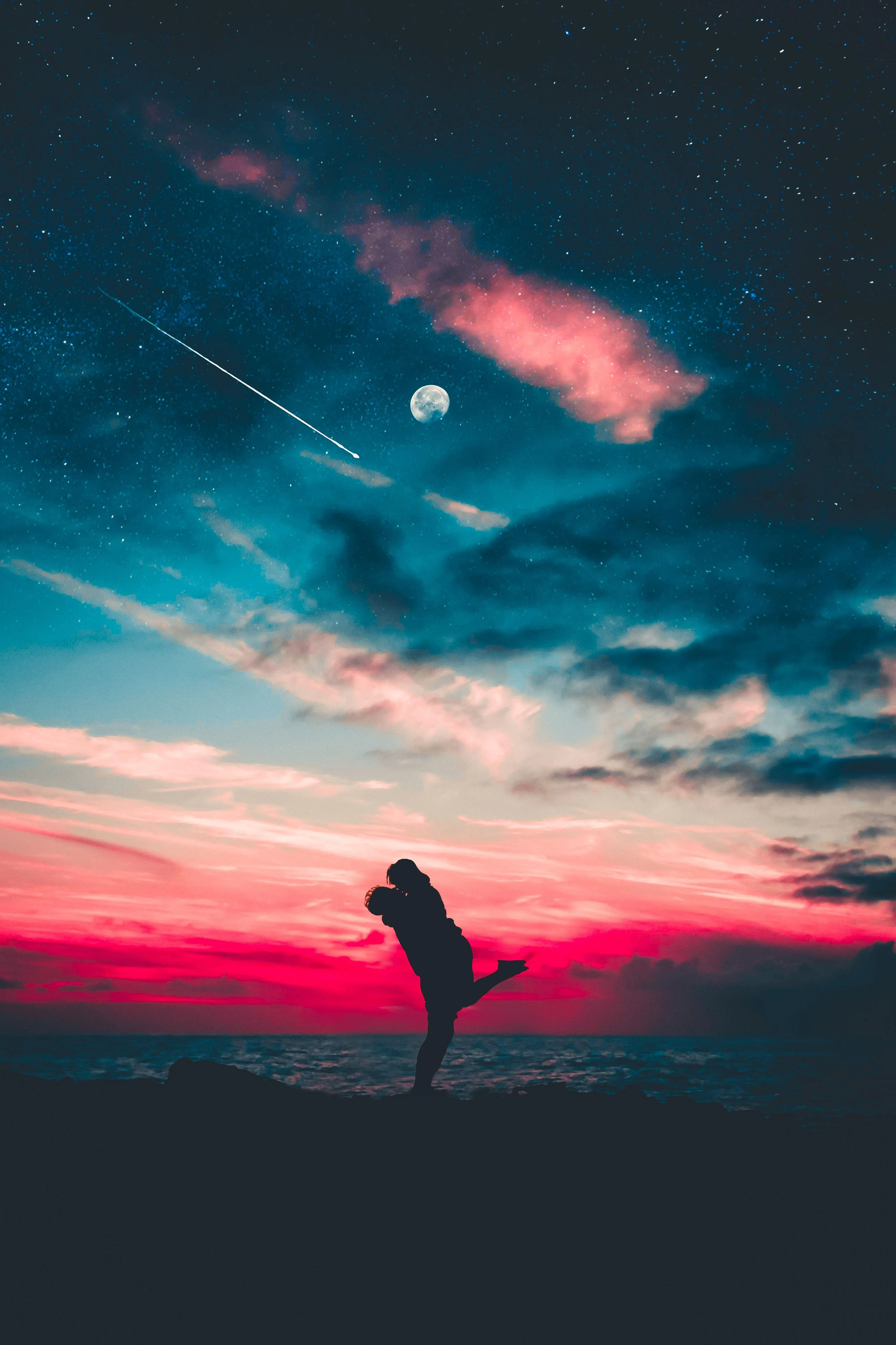 Romantic Sunset Embrace Under Glowing Night Sky Image