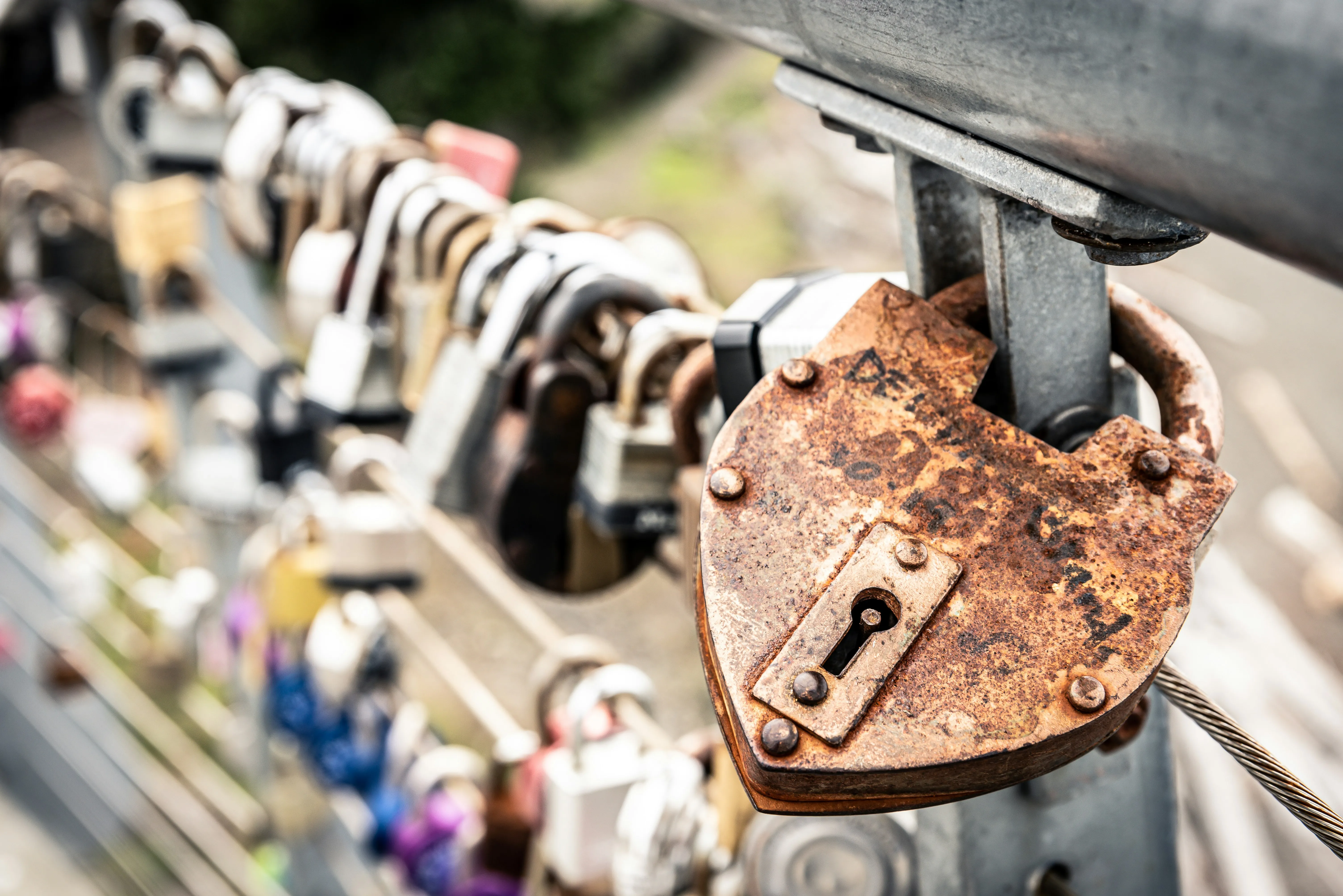 Rusty Love Lock Hanging on Metal Bridge Rail Wallpaper