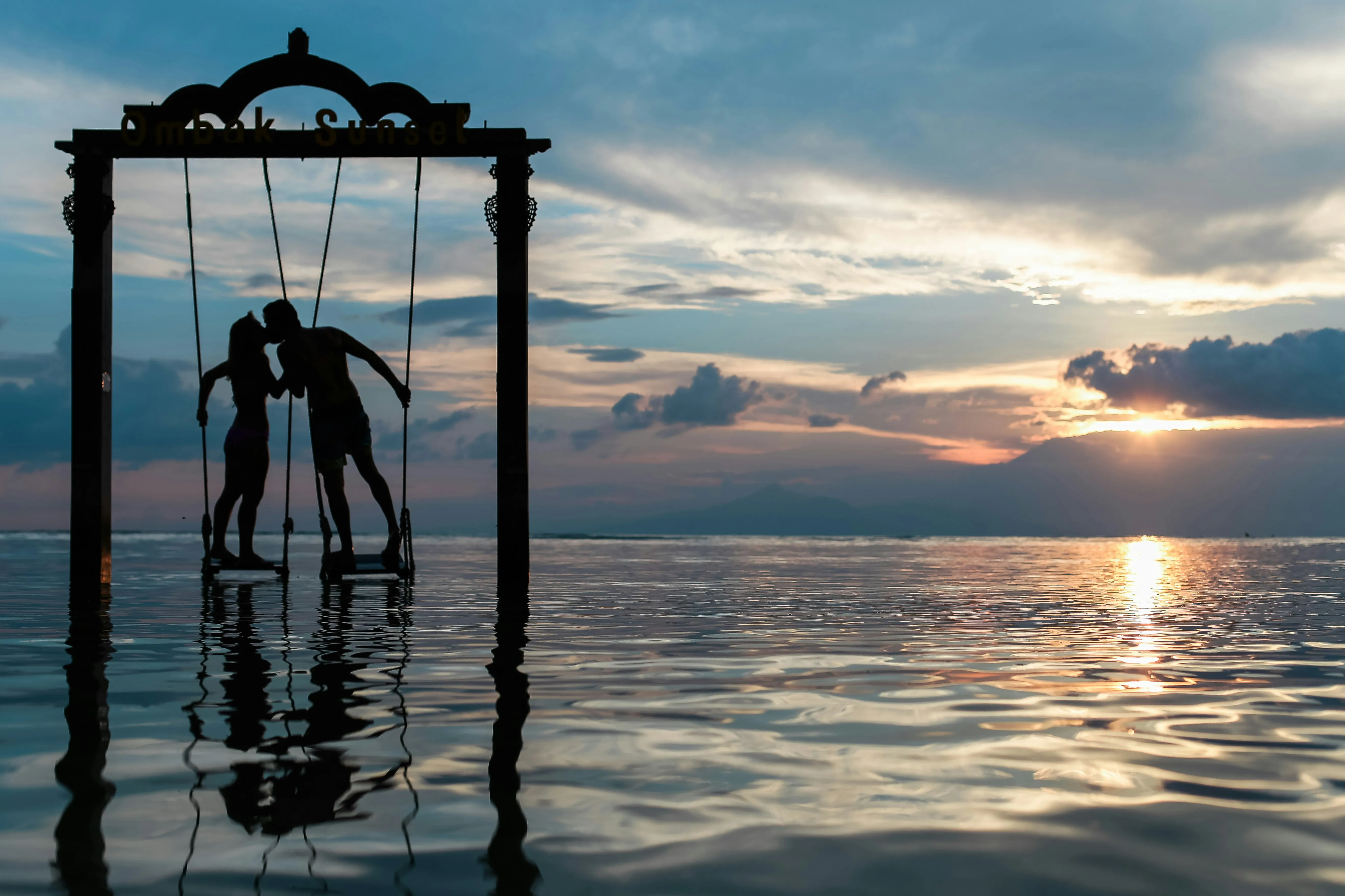Silhouette Couple Standing in Ocean Reflection Wallpaper