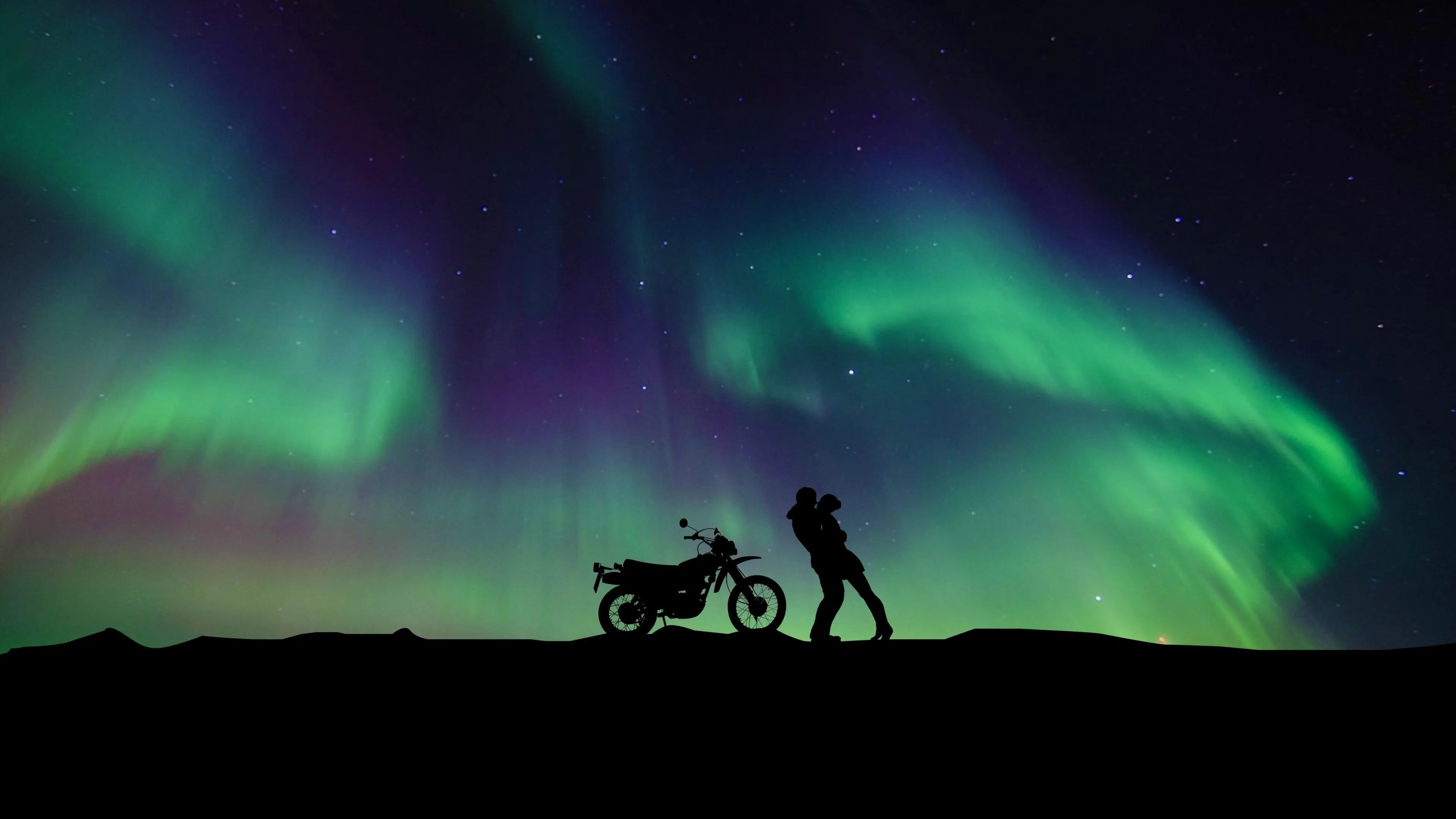Silhouette Under Northern Lights Symbolizing Love Wallpaper
