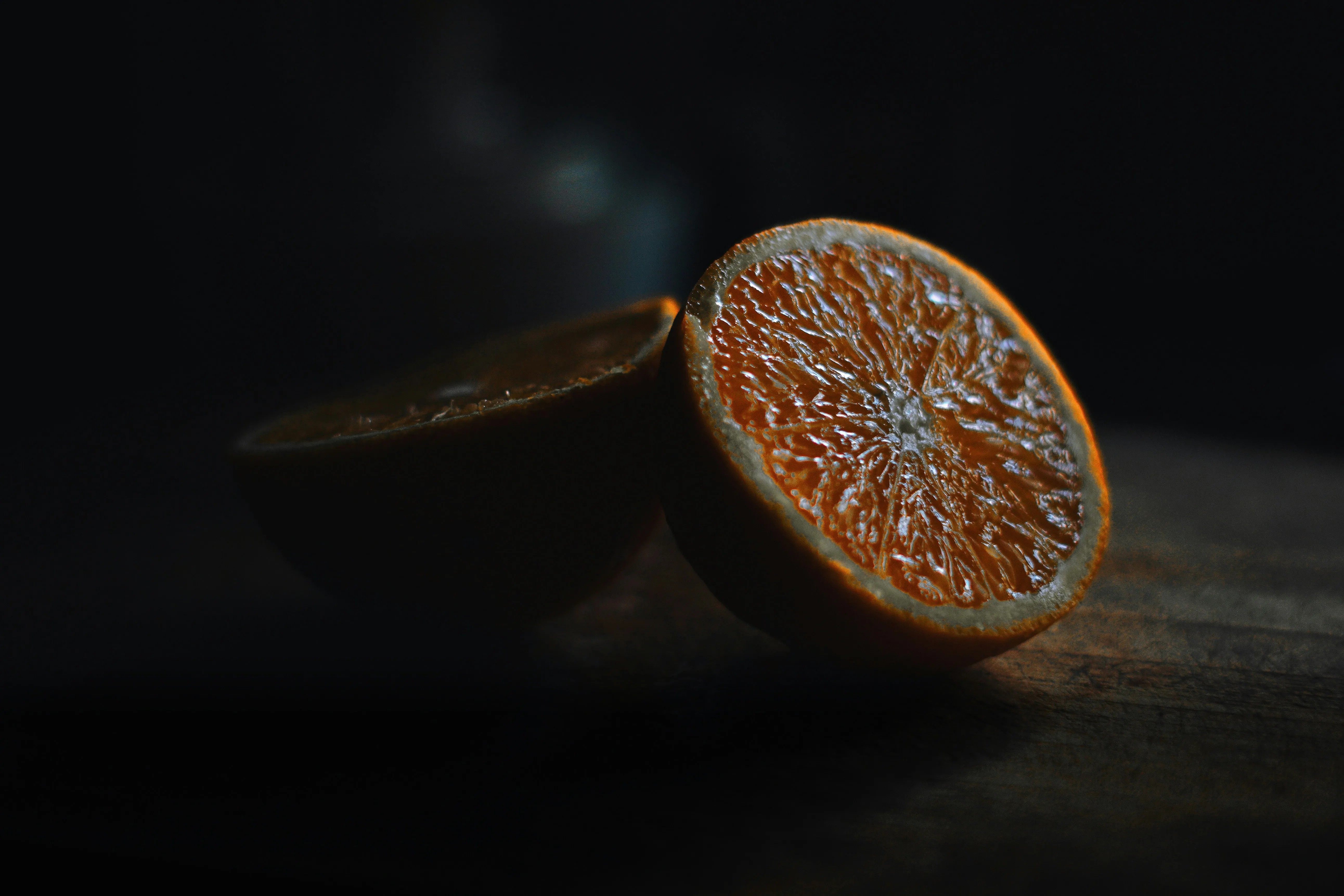 Slice of Orange on Dark Background with Shadow Wallpaper