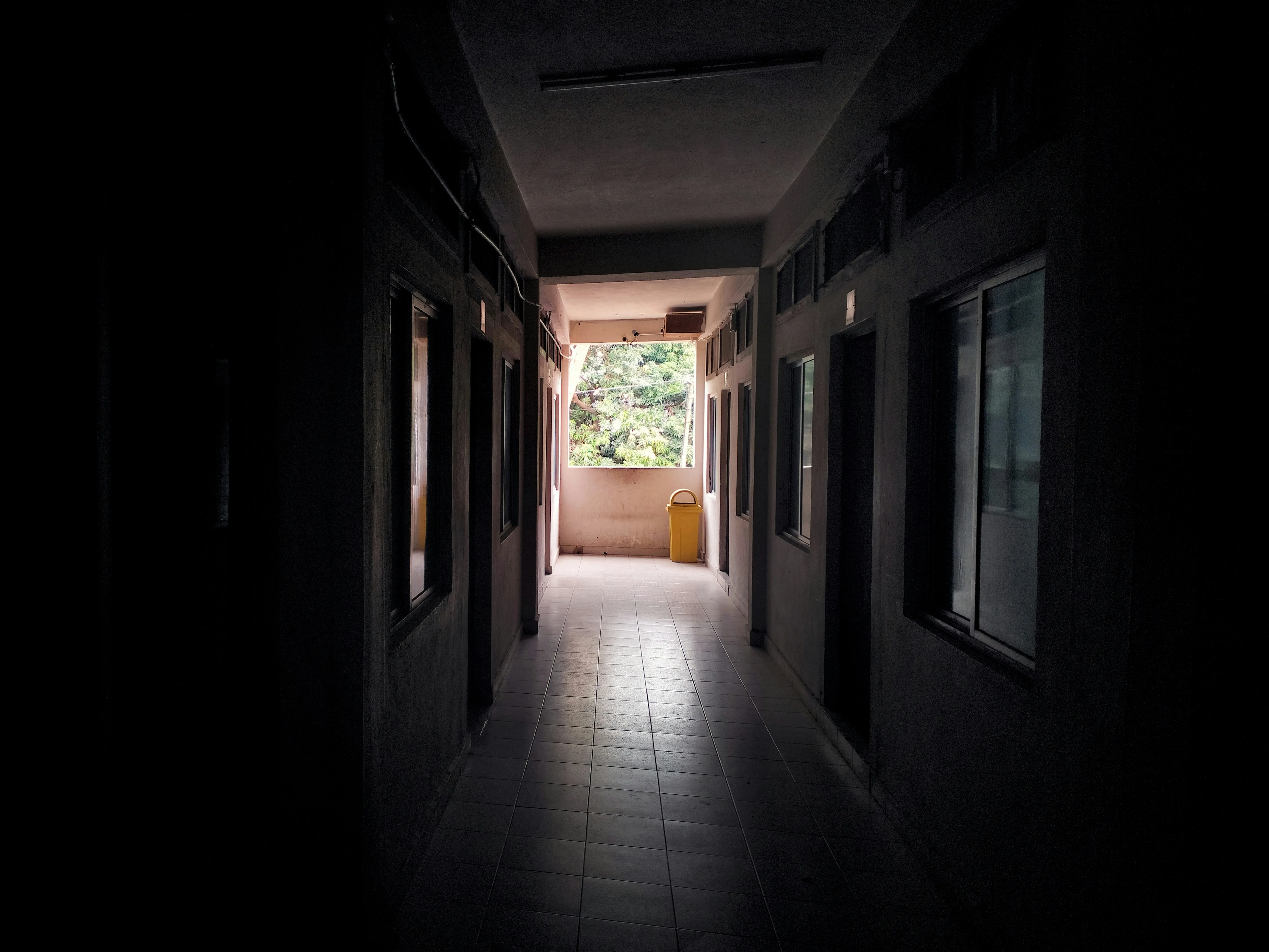 Sunlight Shining Through Dark Peaceful Corridor Wallpaper