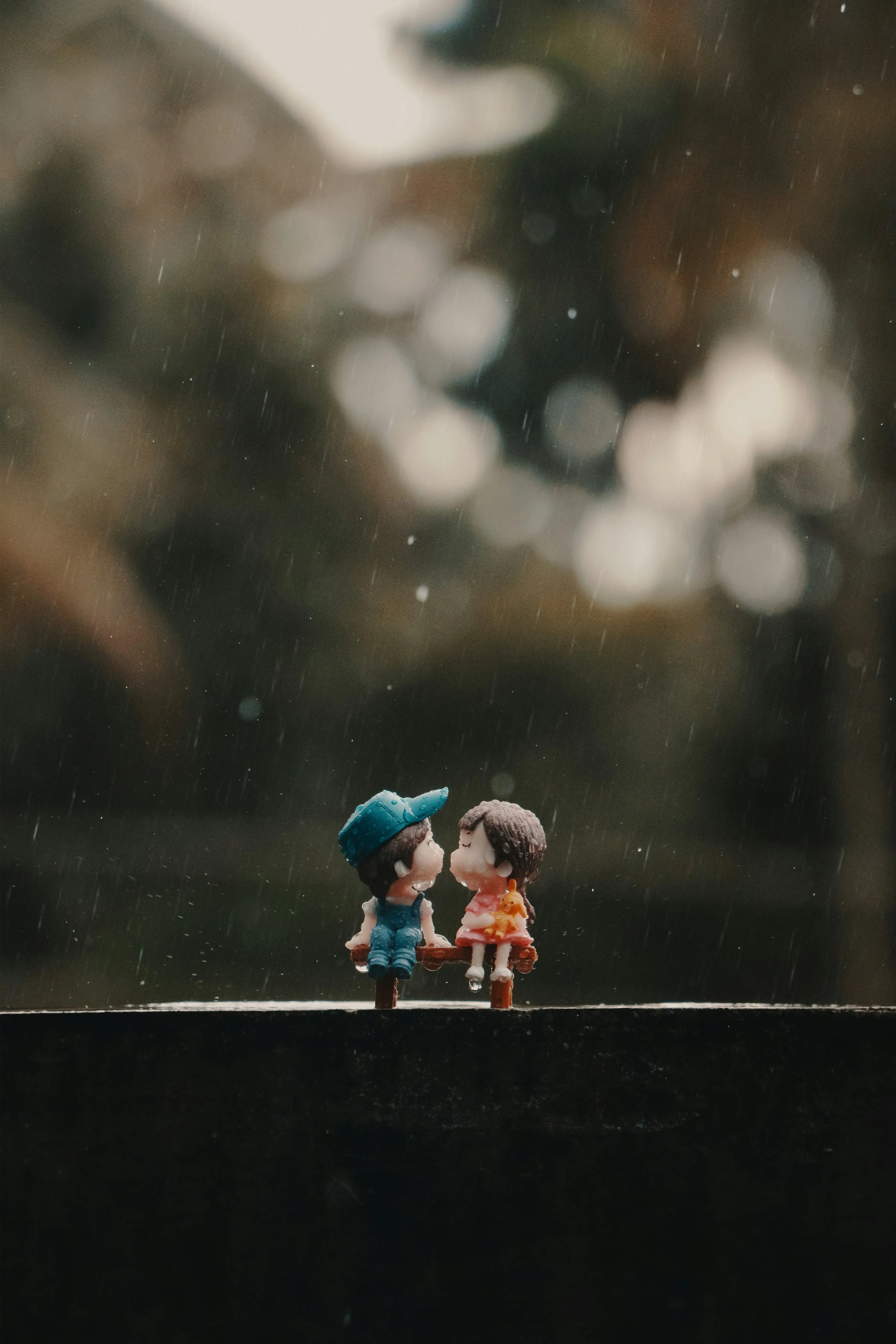 Tiny Toy Figures Sharing Moments in Nature Scene Wallpaper