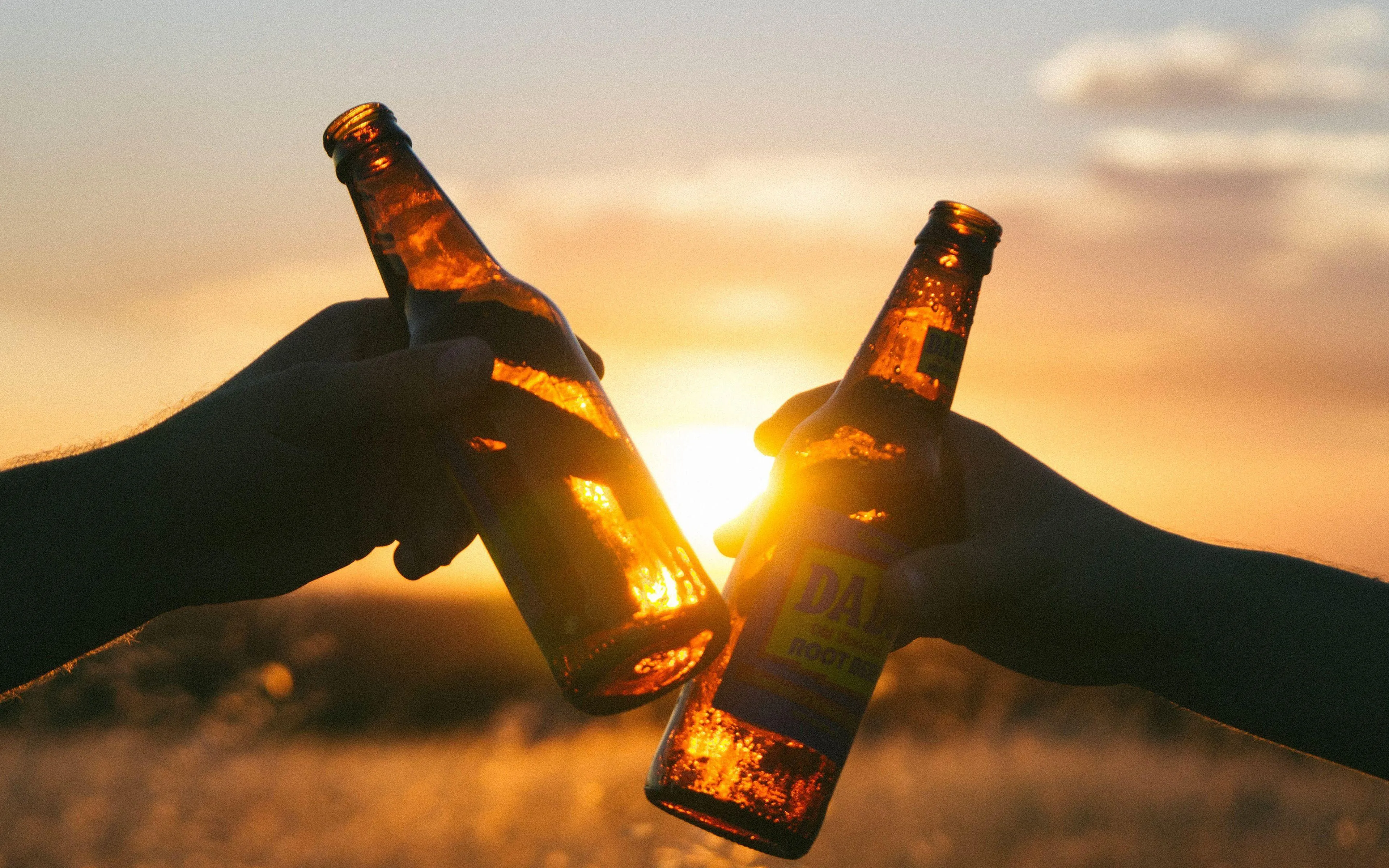 Toasting Bottles Celebrating a Happy Love Moment Wallpaper