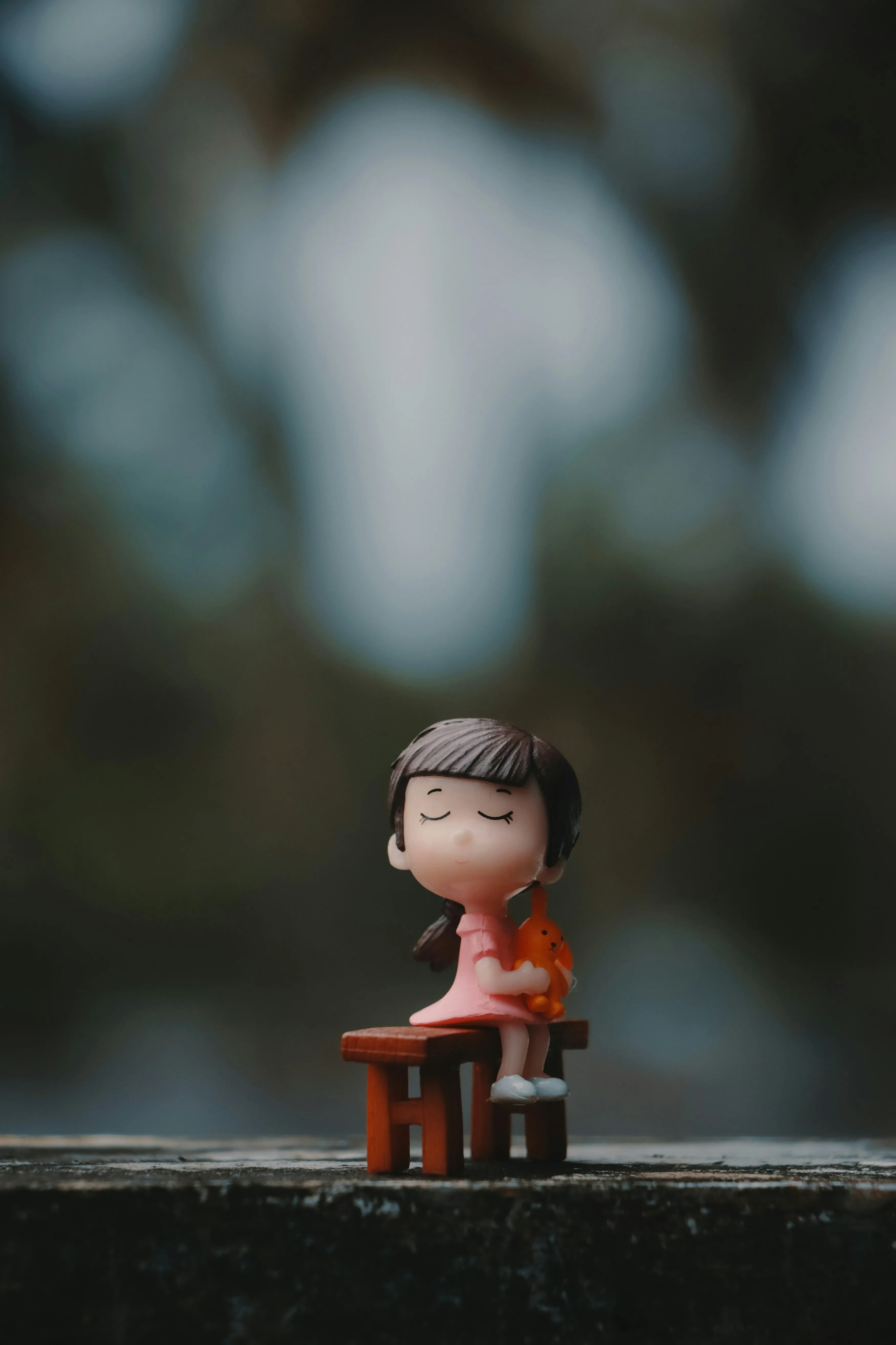 Toy Figurine Sitting Peacefully on Stone Surface Wallpaper
