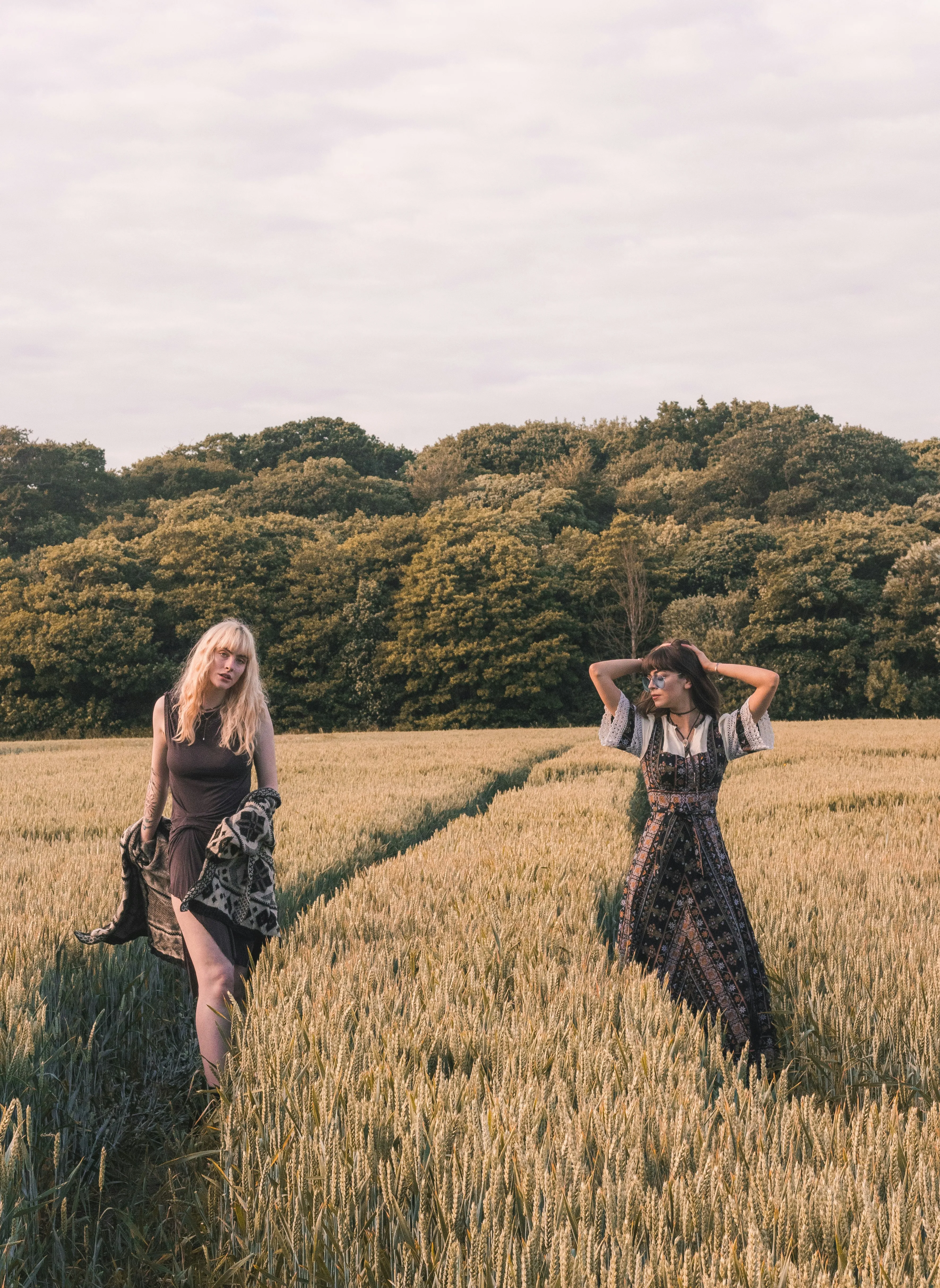 Two Friends Walking Freely in Golden Field Wallpaper