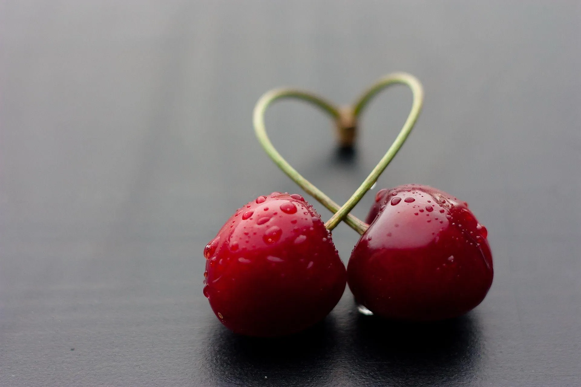 Two Red Cherries with Heart Shape for True Romance Wallpaper