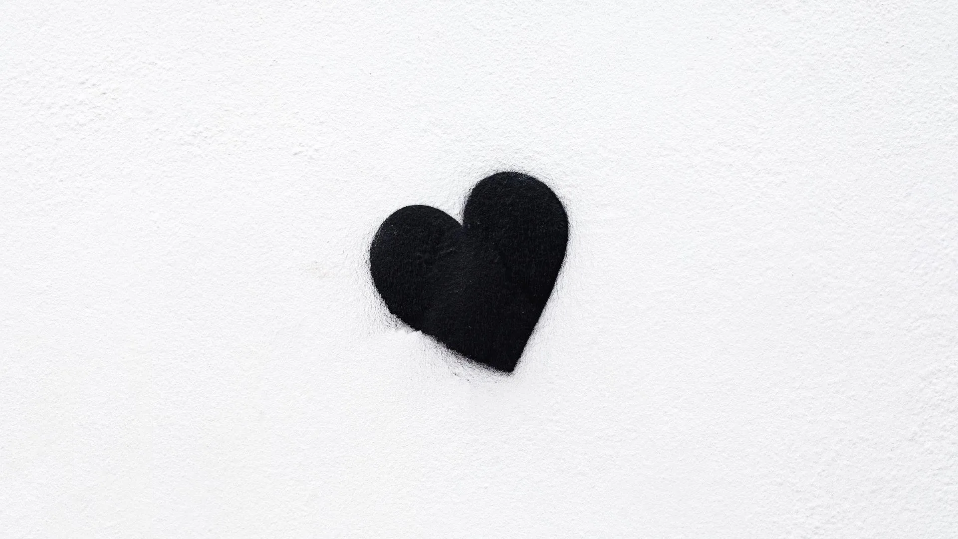 Wallpaper of Small Black Heart on White Paper of Simplicity