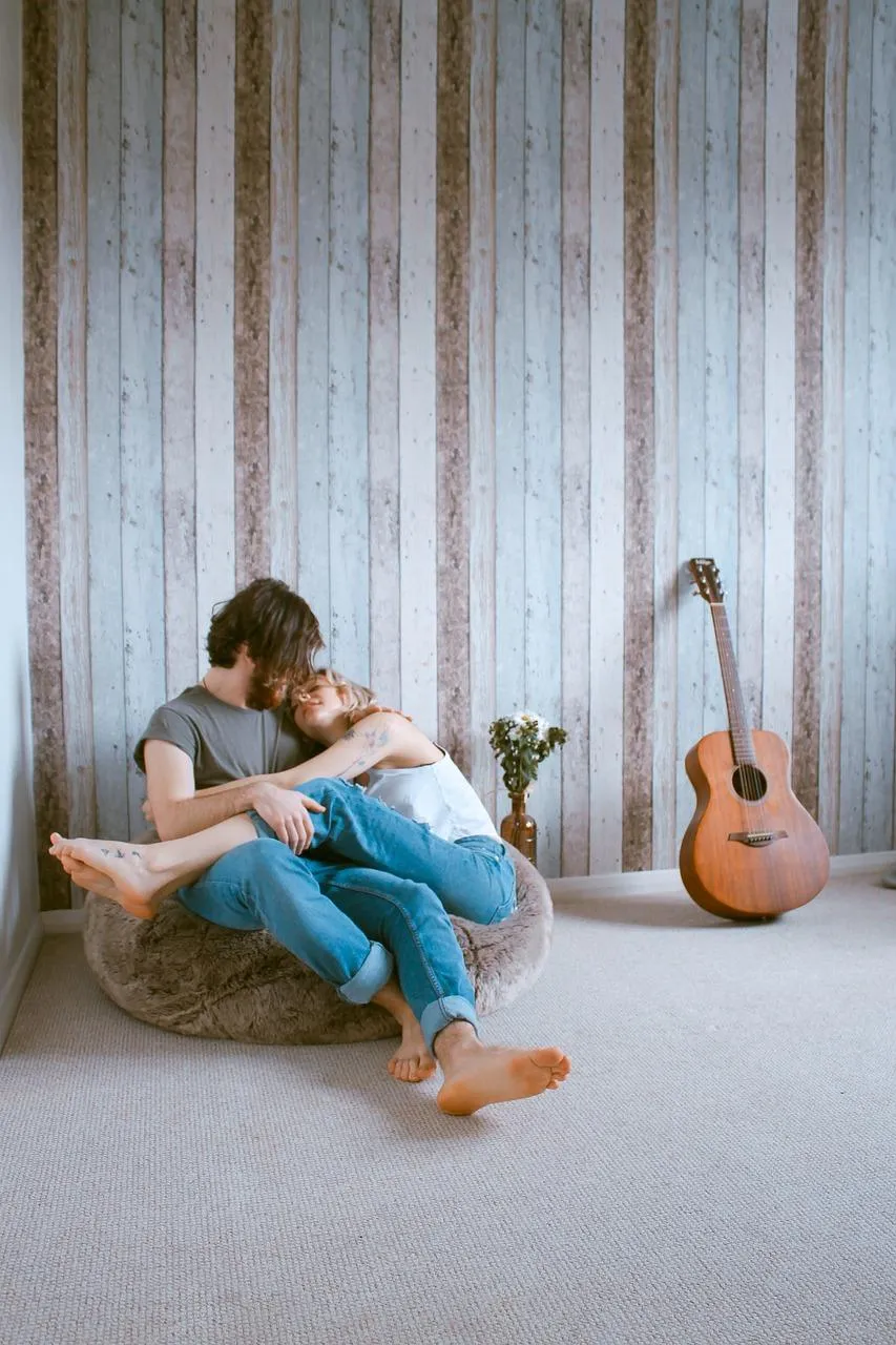 Woman and Man Sitting by Guitar Depicting Peaceful Memory