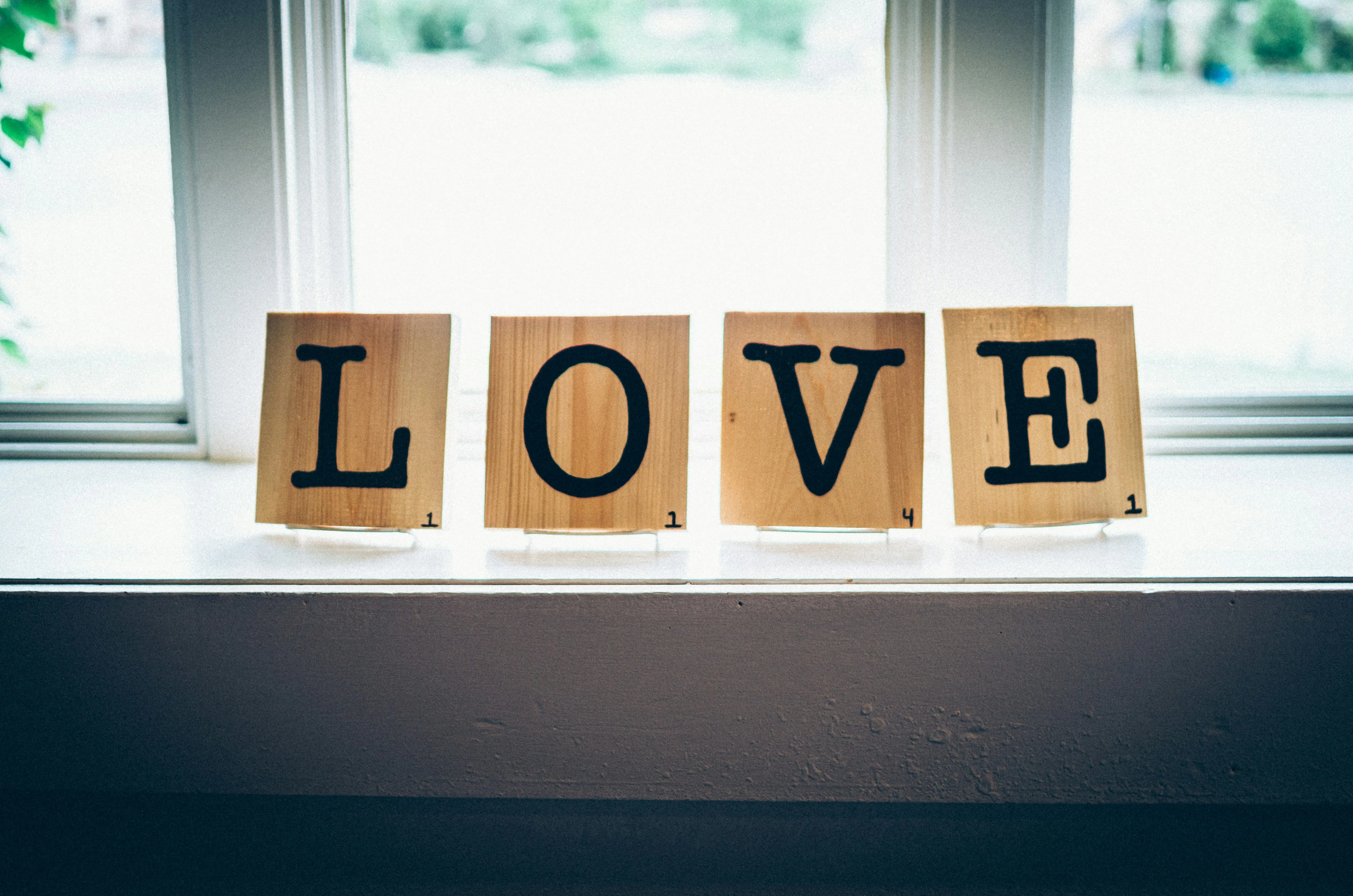 Wooden Blocks Spelling Love Near Bright Window Wallpaper