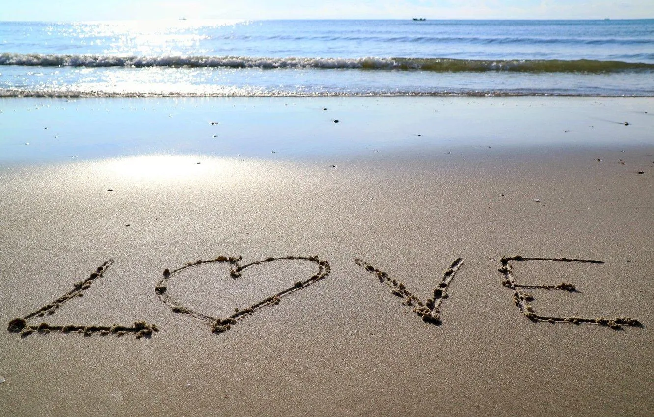 Word Love Written on Beach Sand of Pure Emotion Wallpaper