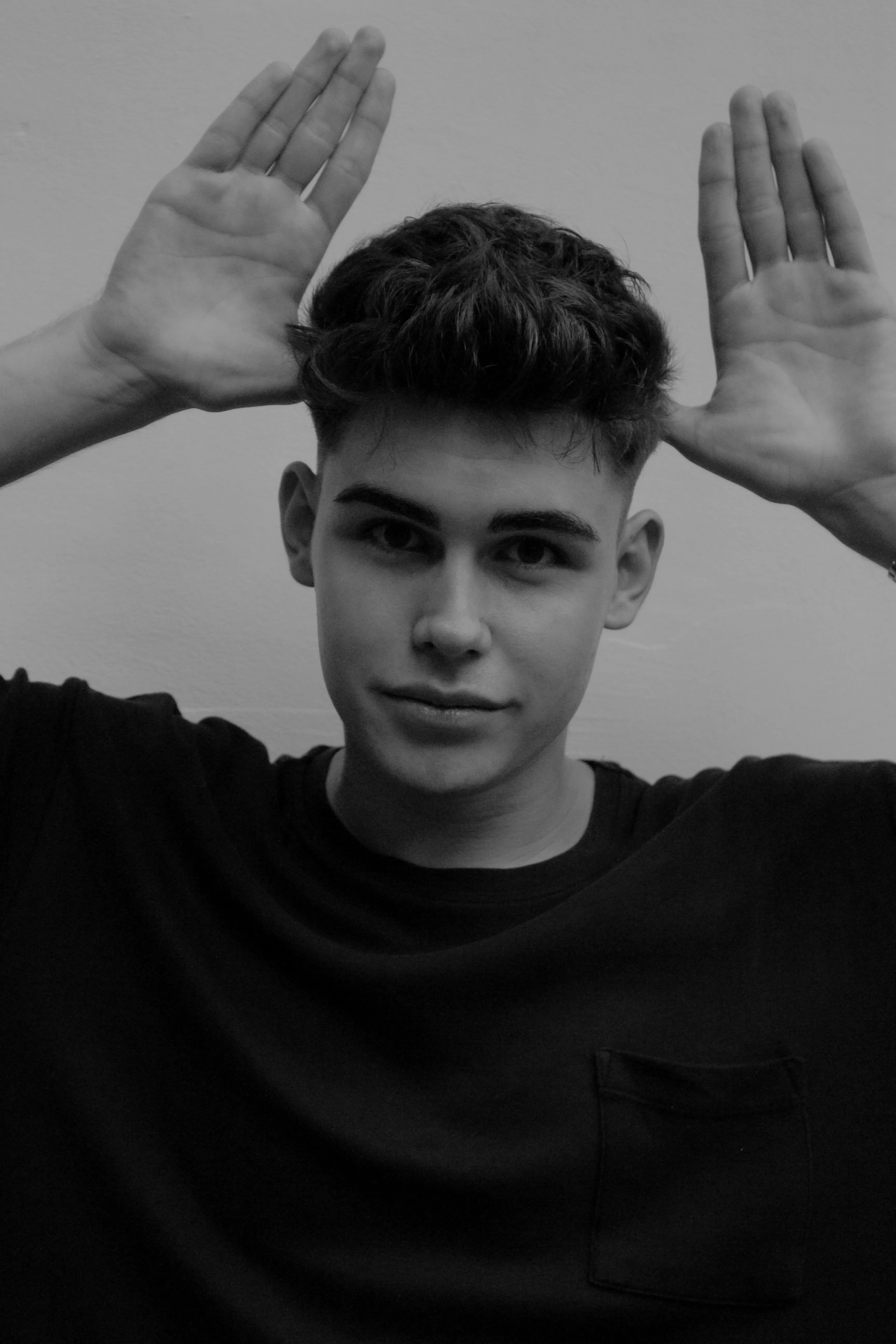 Young Man Posing with Hands Raised in Monochrome Wallpaper