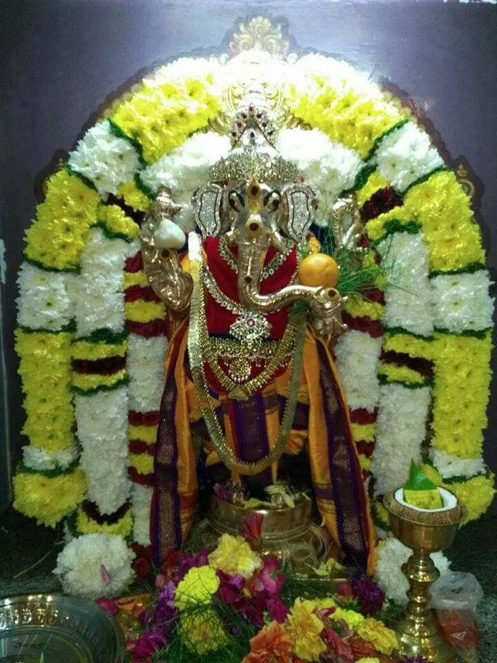 Ganesh Idol Decorated with Flowers and Lights Wallpaper