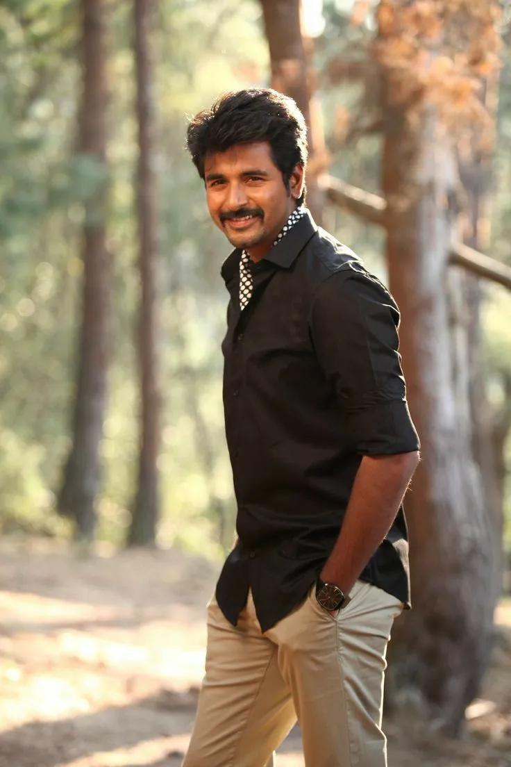Actor Sivakarthikeyan in Black Shirt with Tree Background