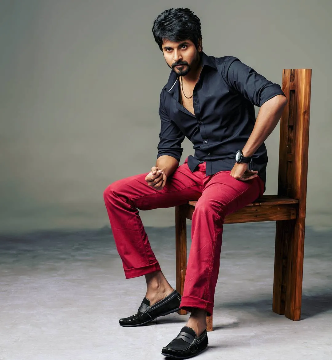Actor Sivakarthikeyan Is Sitting on a Wooden Chair Wallpaper
