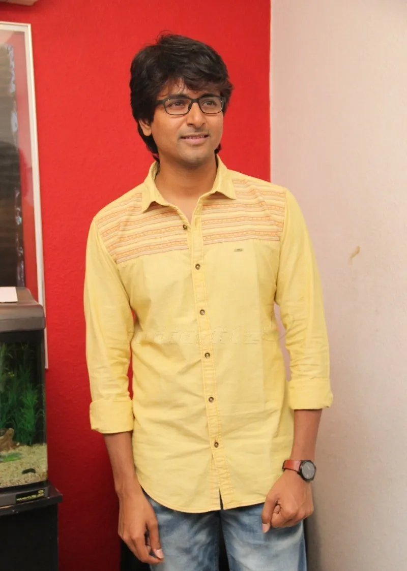 Actor Sivakarthikeyan Standing on a Red and Pink Background