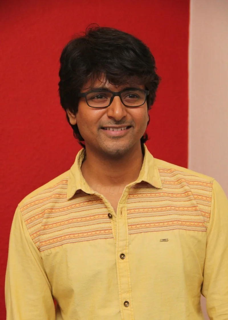 Actor Sivakarthikeyan with Black Glasses Smiling Wallpaper