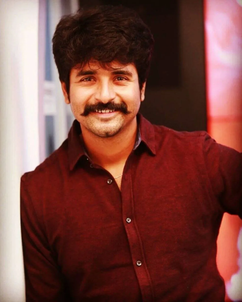 Actor Sivakrthikeyan in Dark Red Shirt Leaning on the Wall