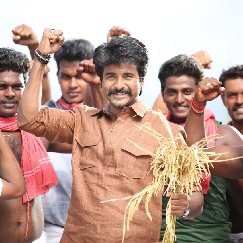 Actor Sk Celebrating with Village Crowd Holding Haystack