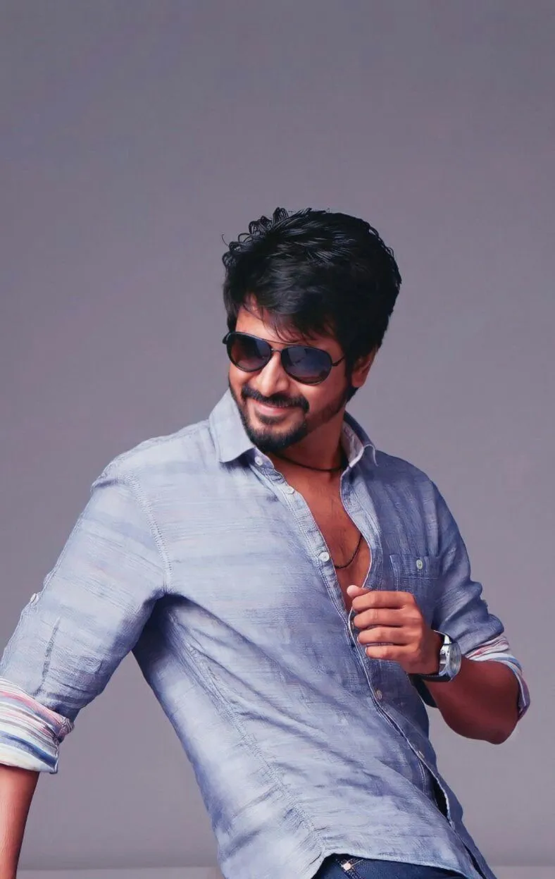 Confident Sivakarthikeyan in Light Blue Shirt and Sunglasses