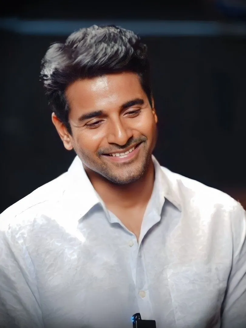 Handsome Sivakarthikeyan Smiling in White Shirt Wallpaper