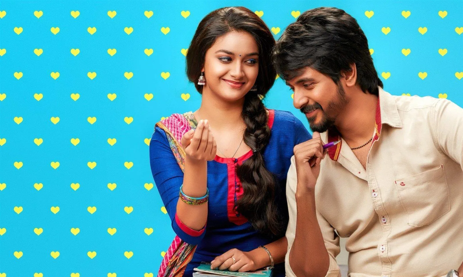 Keerthi Suresh and Sk in Playful Pose with Blue Background