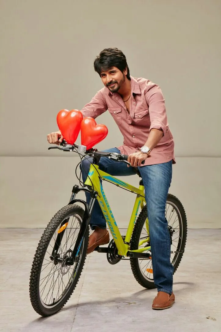 Remo Movie Image of Sivakarthikeyan Sitting on a Yellow Cycle