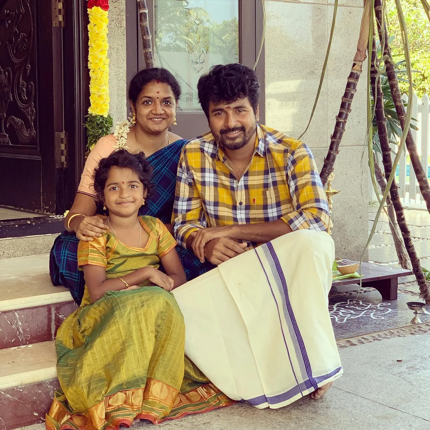 Sivakarthikeyan and His Family Sitting on the Home Steps