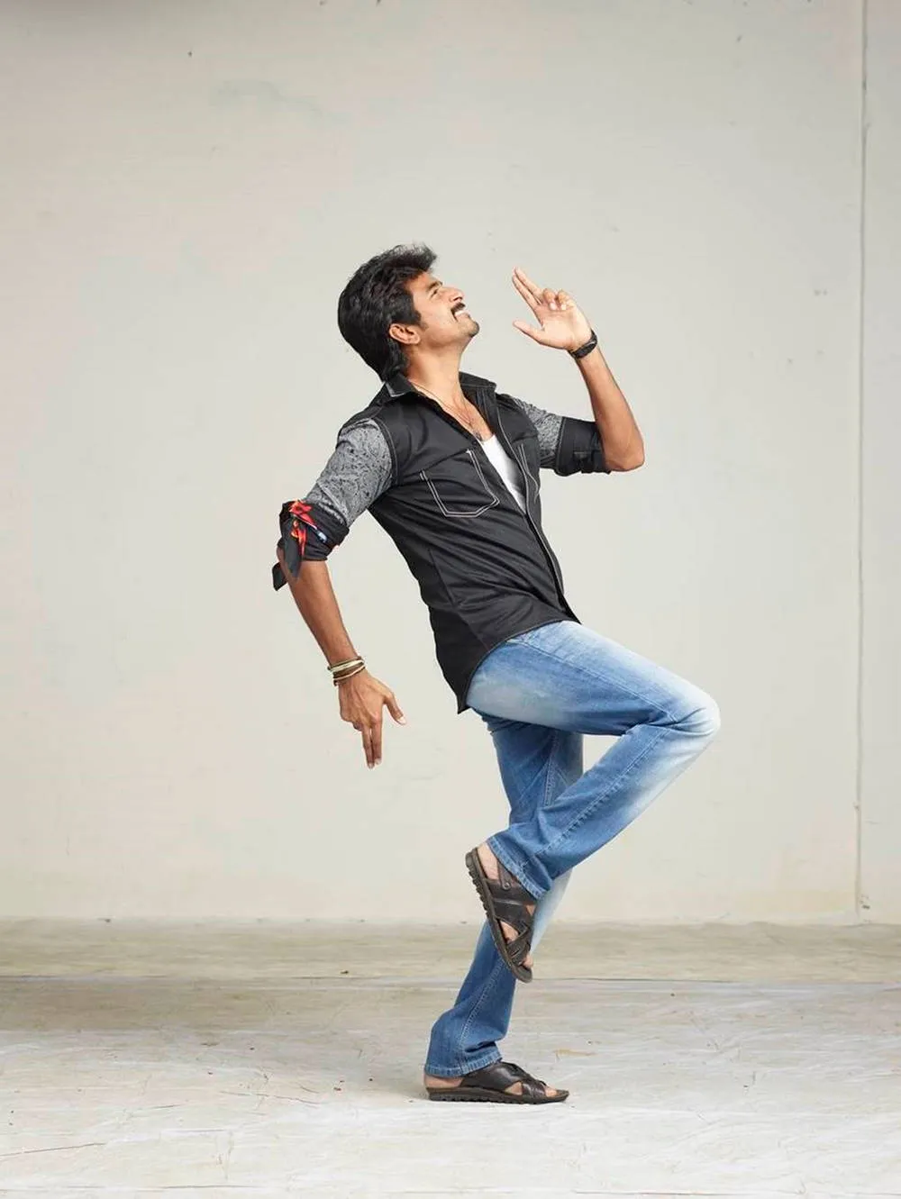 Sivakarthikeyan Dancing Pose in Studio with Gray Background
