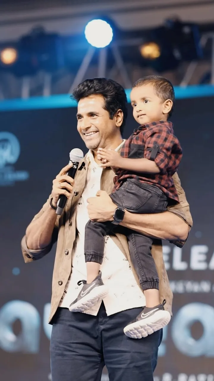 Sivakarthikeyan Holding Gugan on Stage During the Event