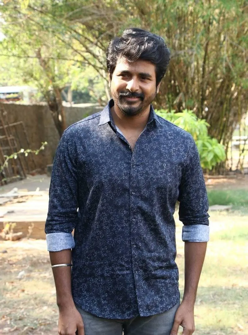 Sivakarthikeyan in Dark Blue Shirt and Gray Jeans Wallpaper