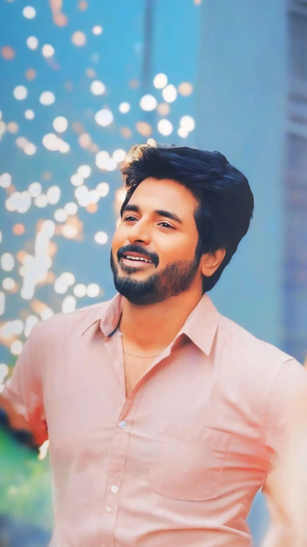 Sivakarthikeyan in Pink Shirt Smiling Under Glowing Lights