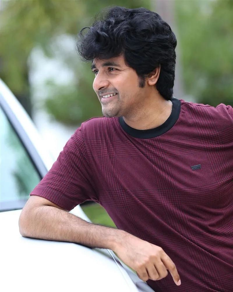 Sivakarthikeyan in T Shirt Resting His Hands on the Car