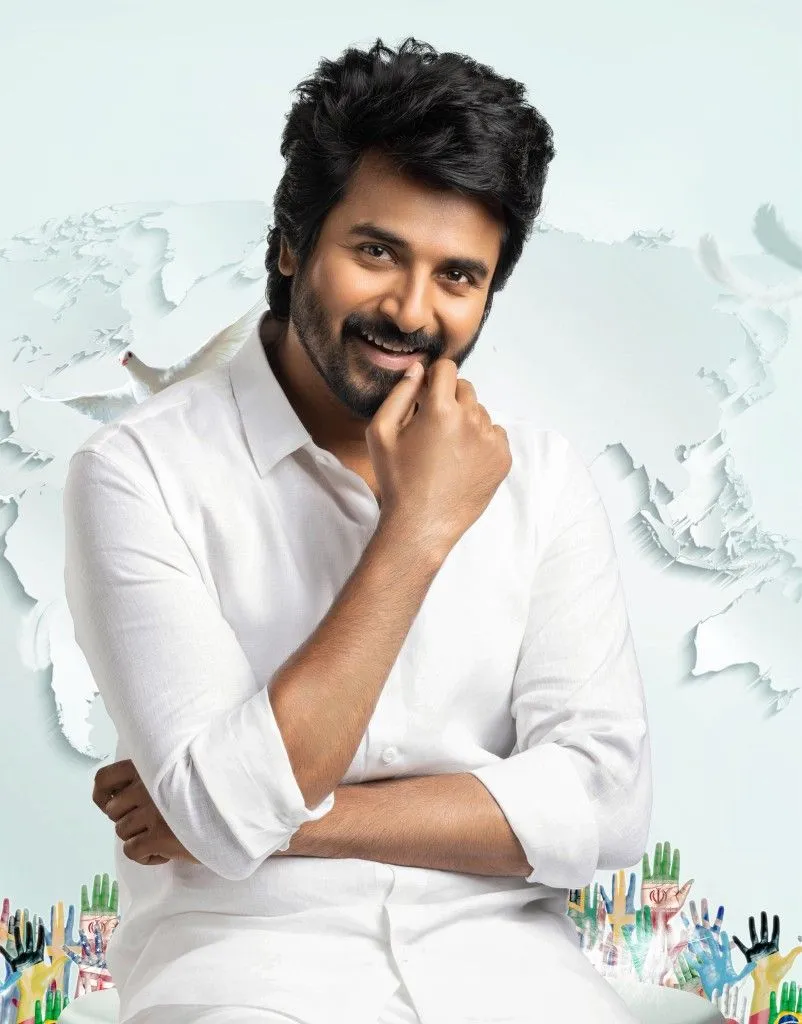 Sivakarthikeyan in White Shirt Smiling with World Map Backdrop